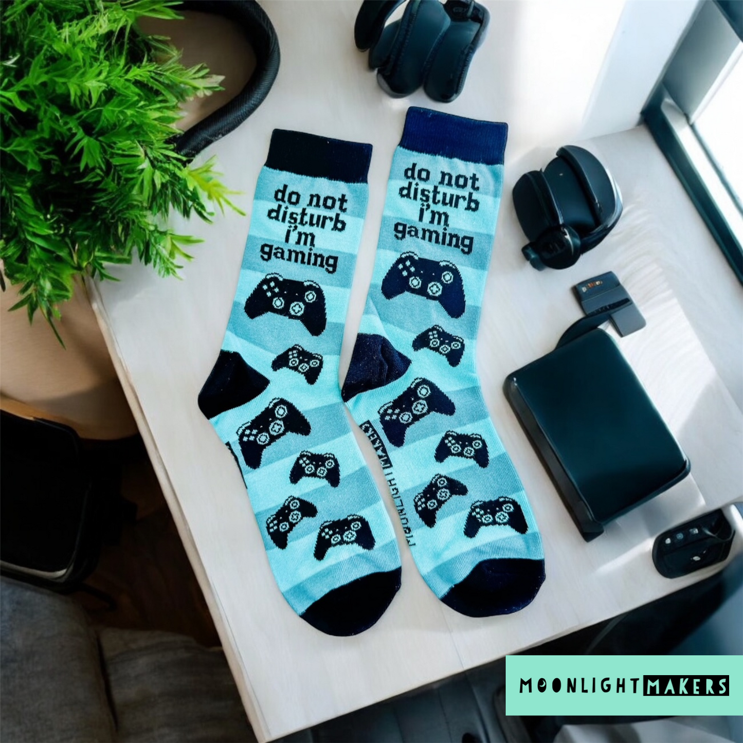 a pair of socks that say, do not disturb i'm gaming