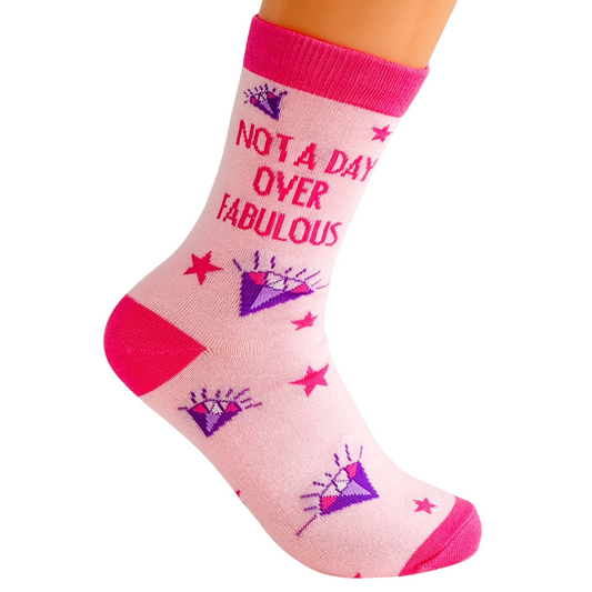 a pair of pink socks that say not a day over fabulous