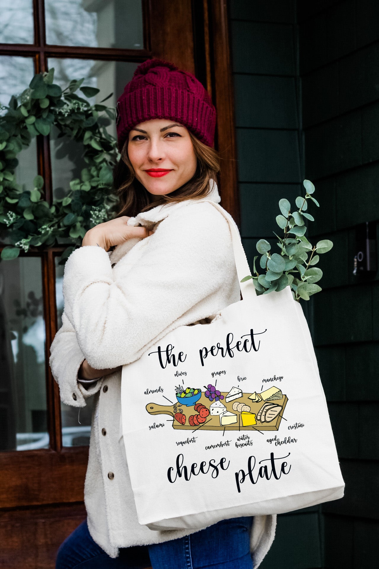 a woman is holding a bag with the words the perfect cheese plate