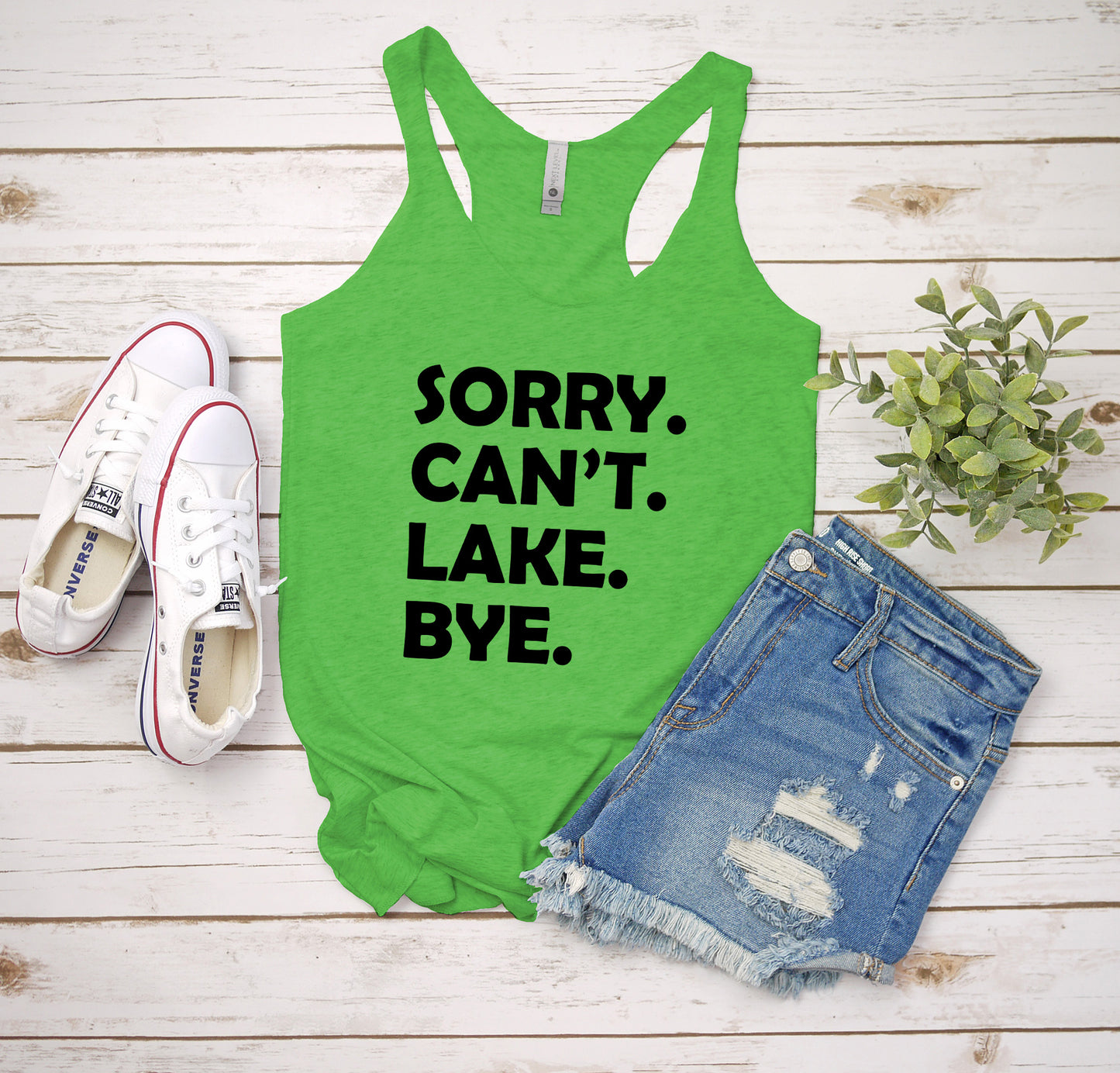 a green tank top that says sorry can't lake bye