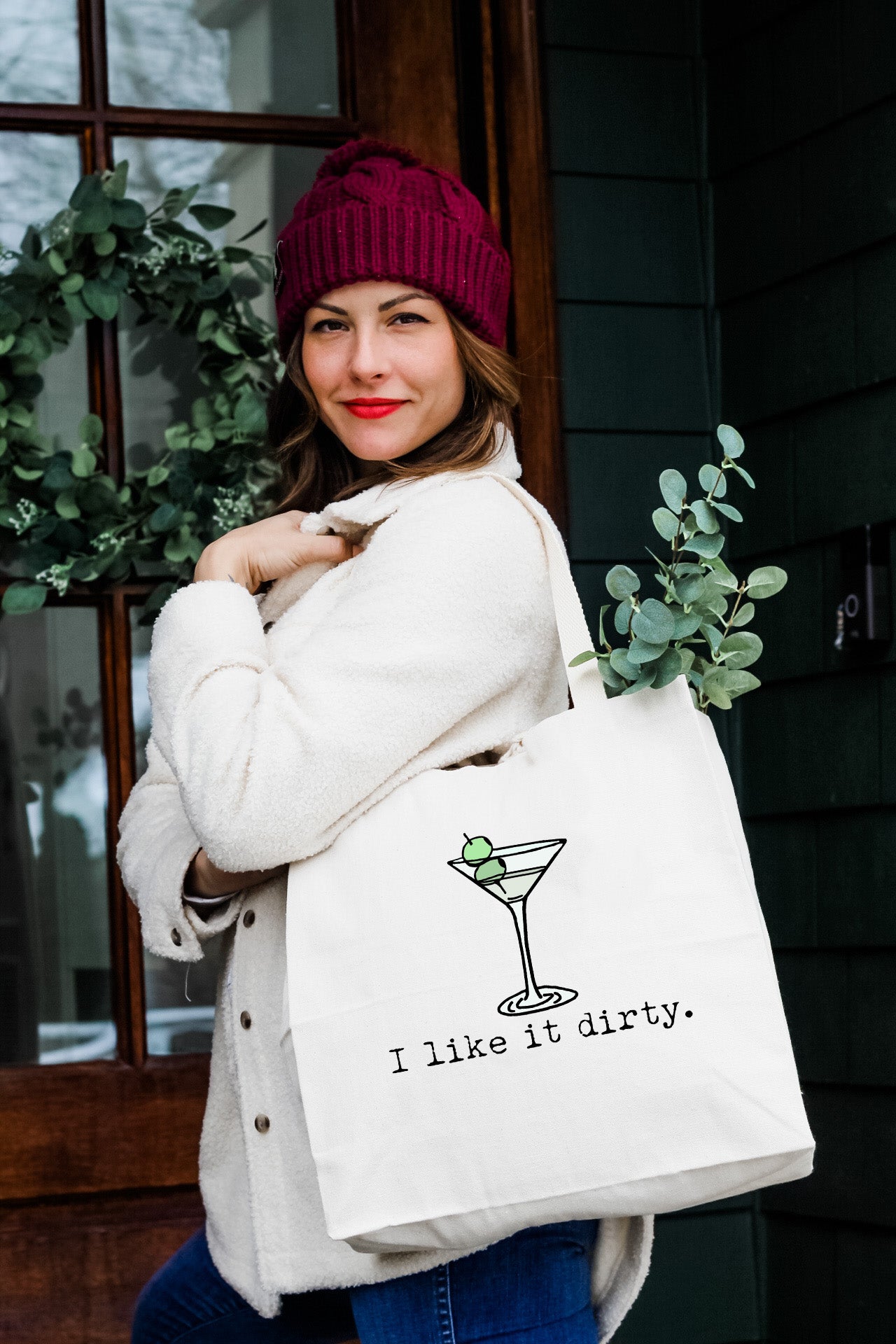 a woman carrying a white bag that says i like it dirty