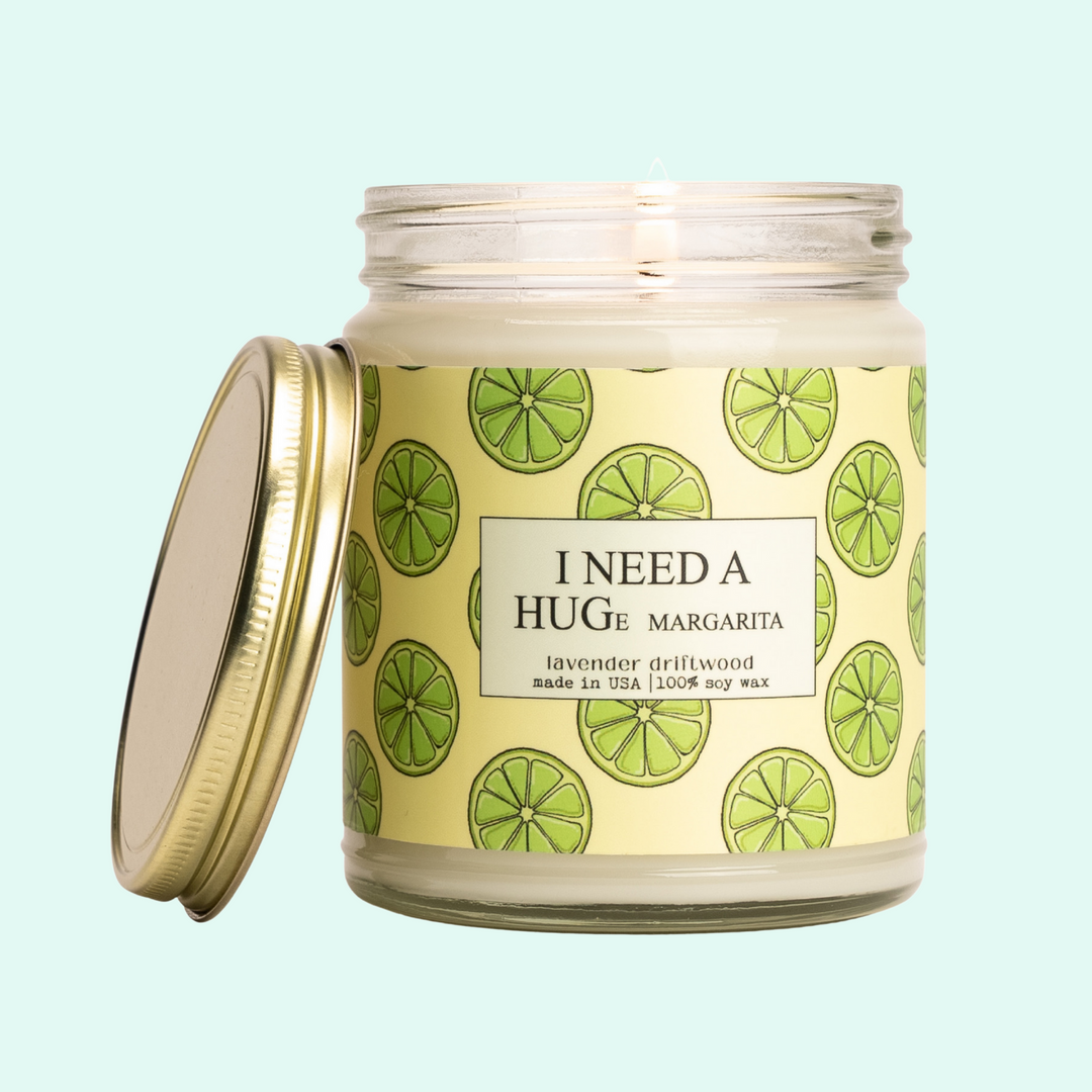 a candle with a lid that has limes on it