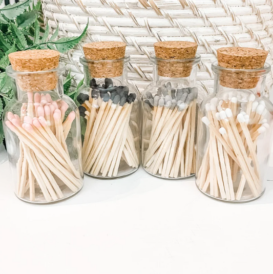 a row of glass jars filled with matches