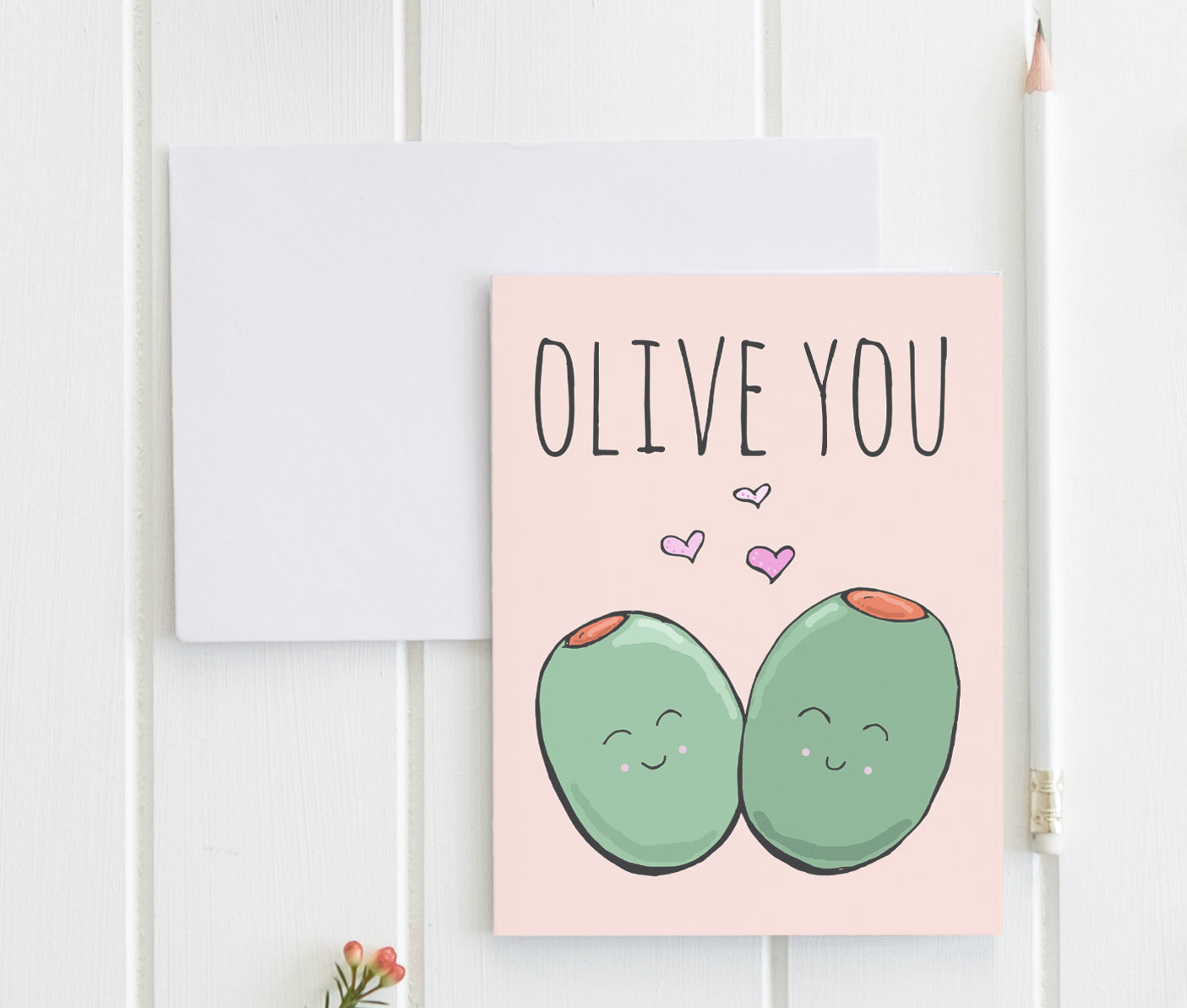 a greeting card with two green eggs on a pink background