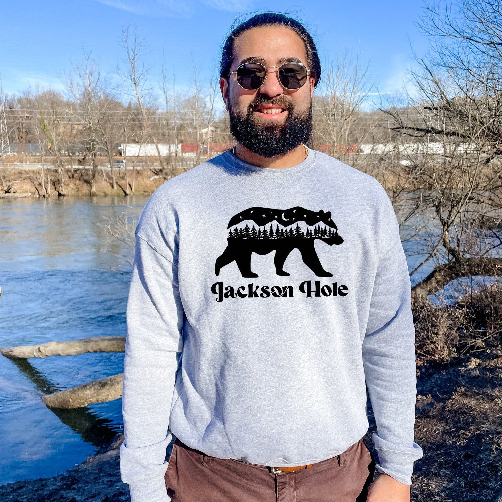 a man standing in front of a body of water