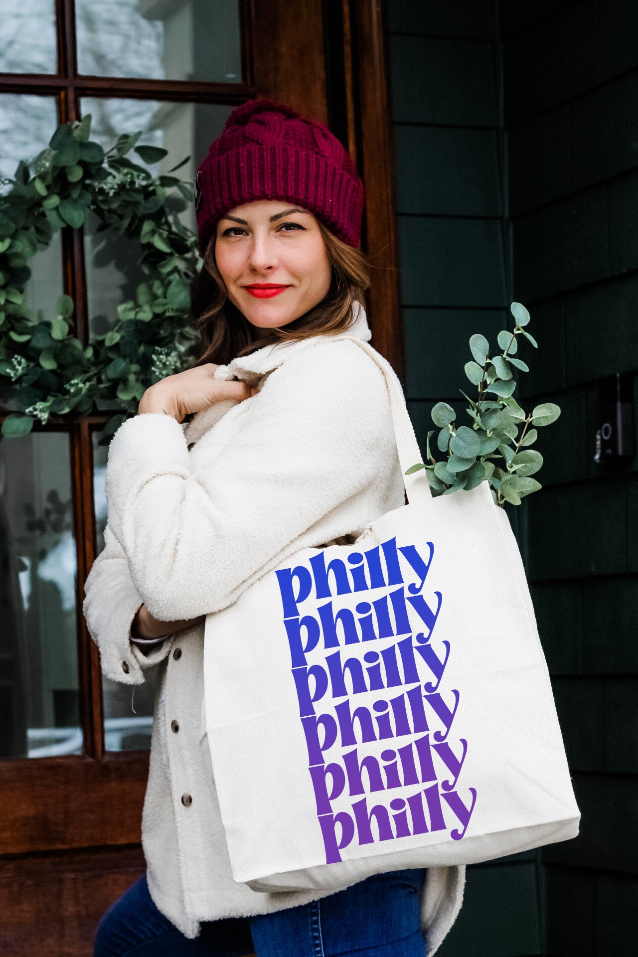 a woman is holding a bag with the phrase philly philly philly phil