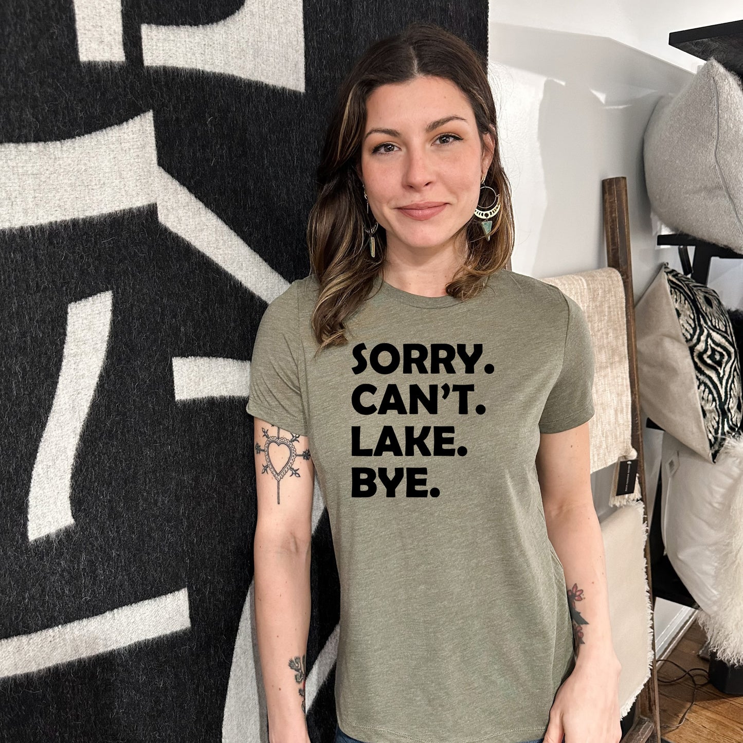 a woman wearing a t - shirt that says sorry, can't lake bye