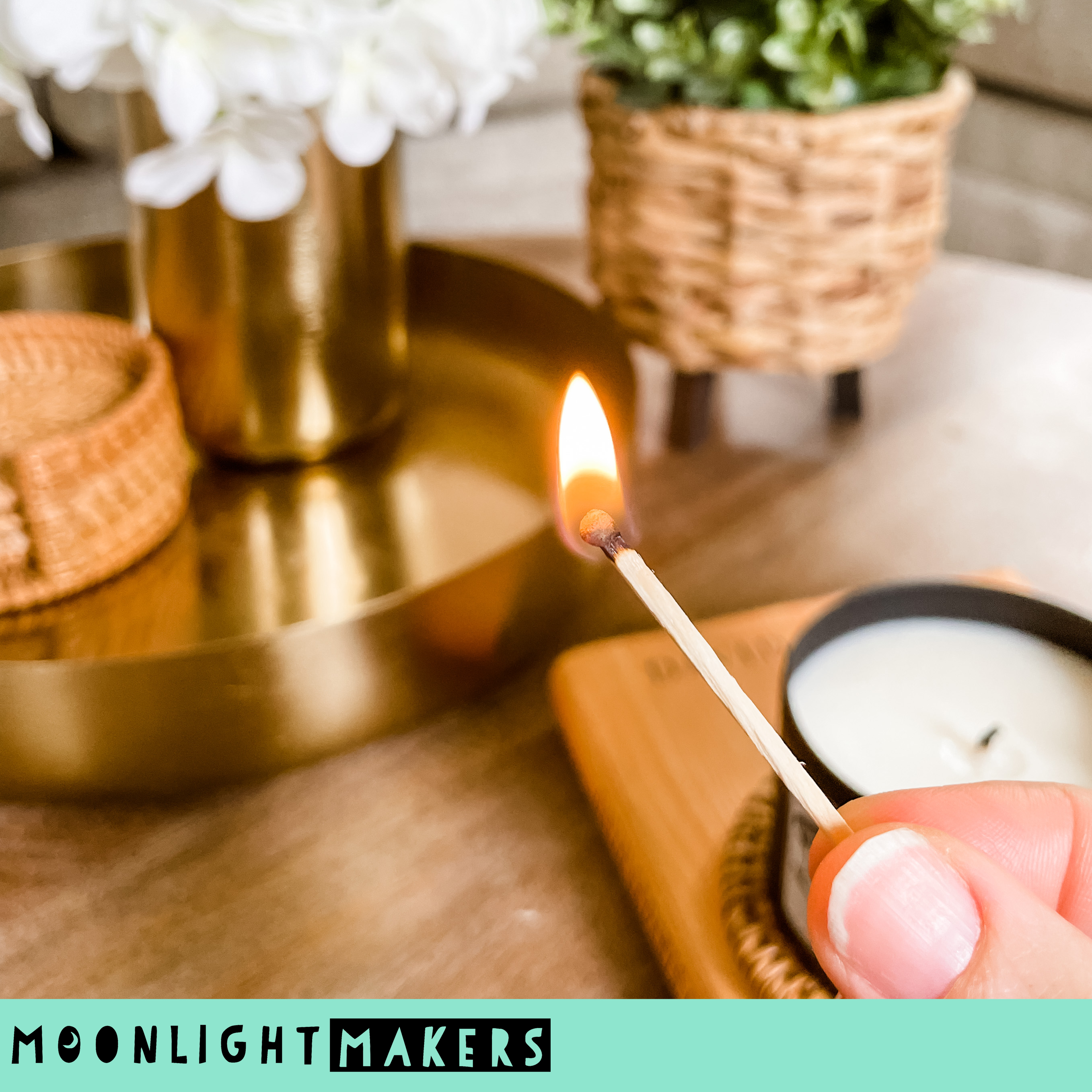a person lighting a candle on a tray
