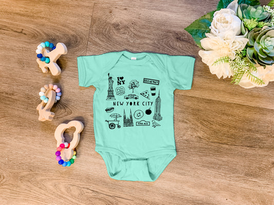 a baby's bodysuit with a picture of the city