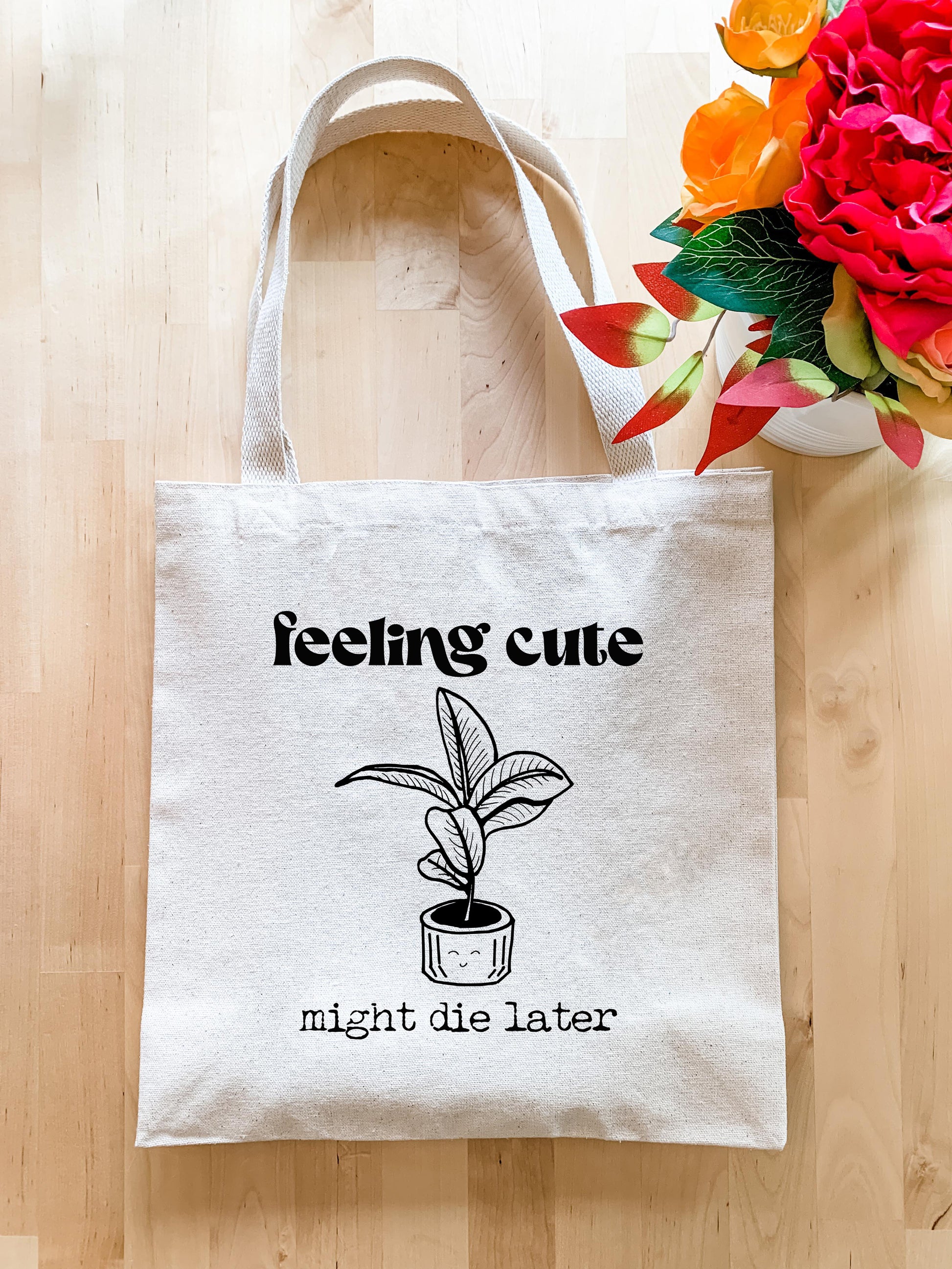 a white tote bag with a plant on it