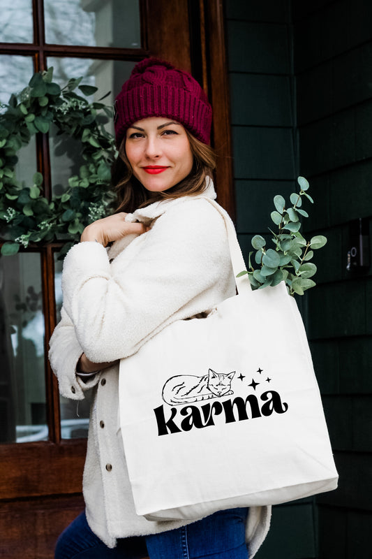 a woman carrying a white bag with the word karmia printed on it
