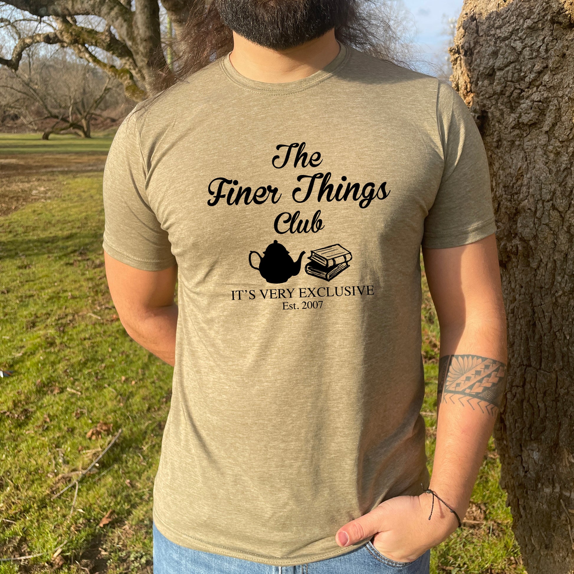 a man with a beard wearing a t - shirt that says the finer things club