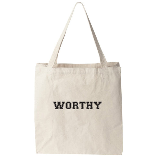 a white tote bag with the word worthy printed on it