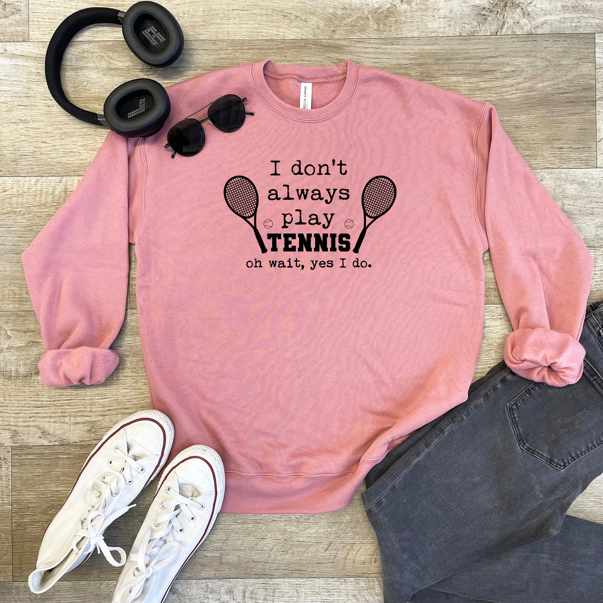 a pink sweatshirt with a pair of headphones and a pair of black headphones