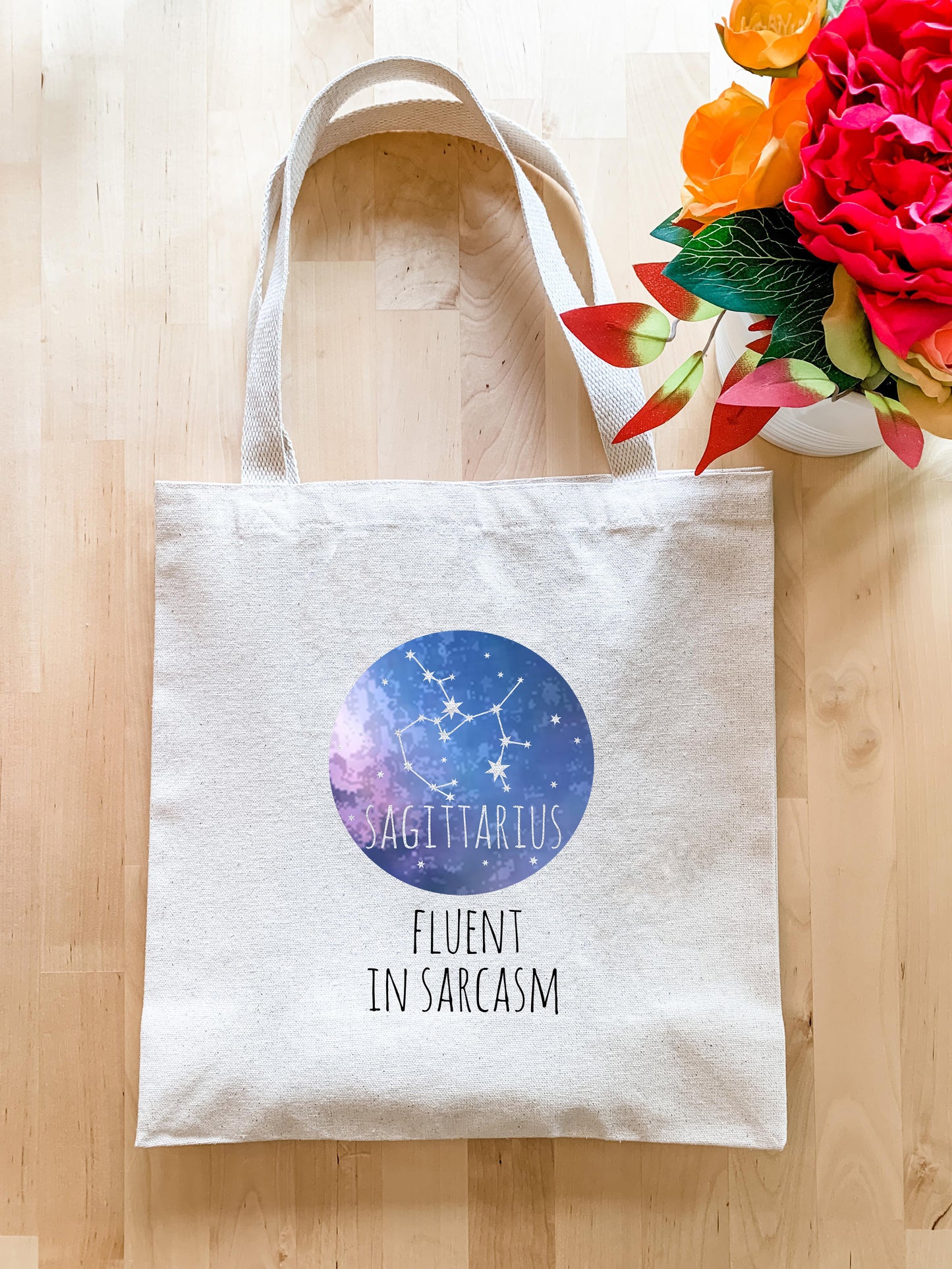 a white tote bag with the words sagittarius fluent in sar