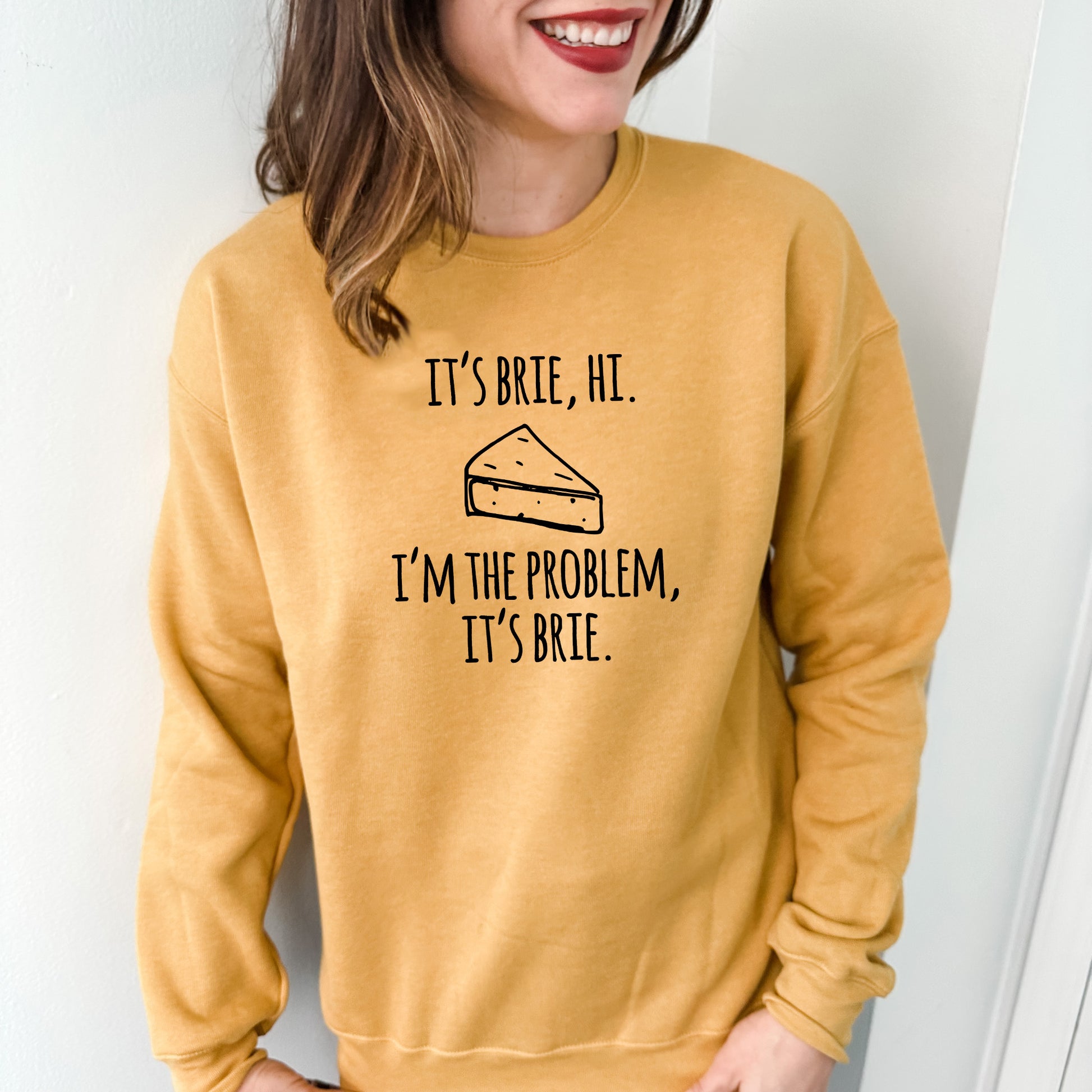 a woman wearing a sweatshirt that says it's brie, he i '