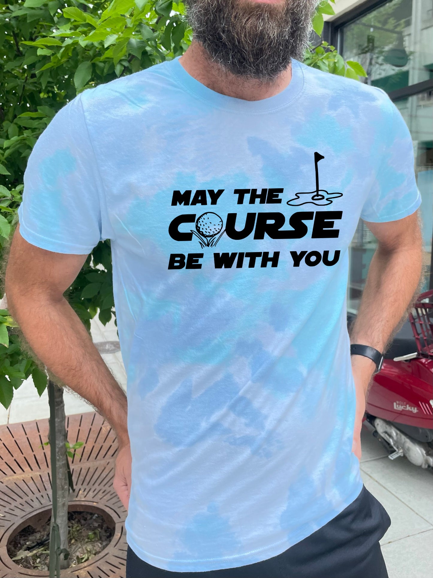 a man with a beard wearing a t - shirt that says may the course be