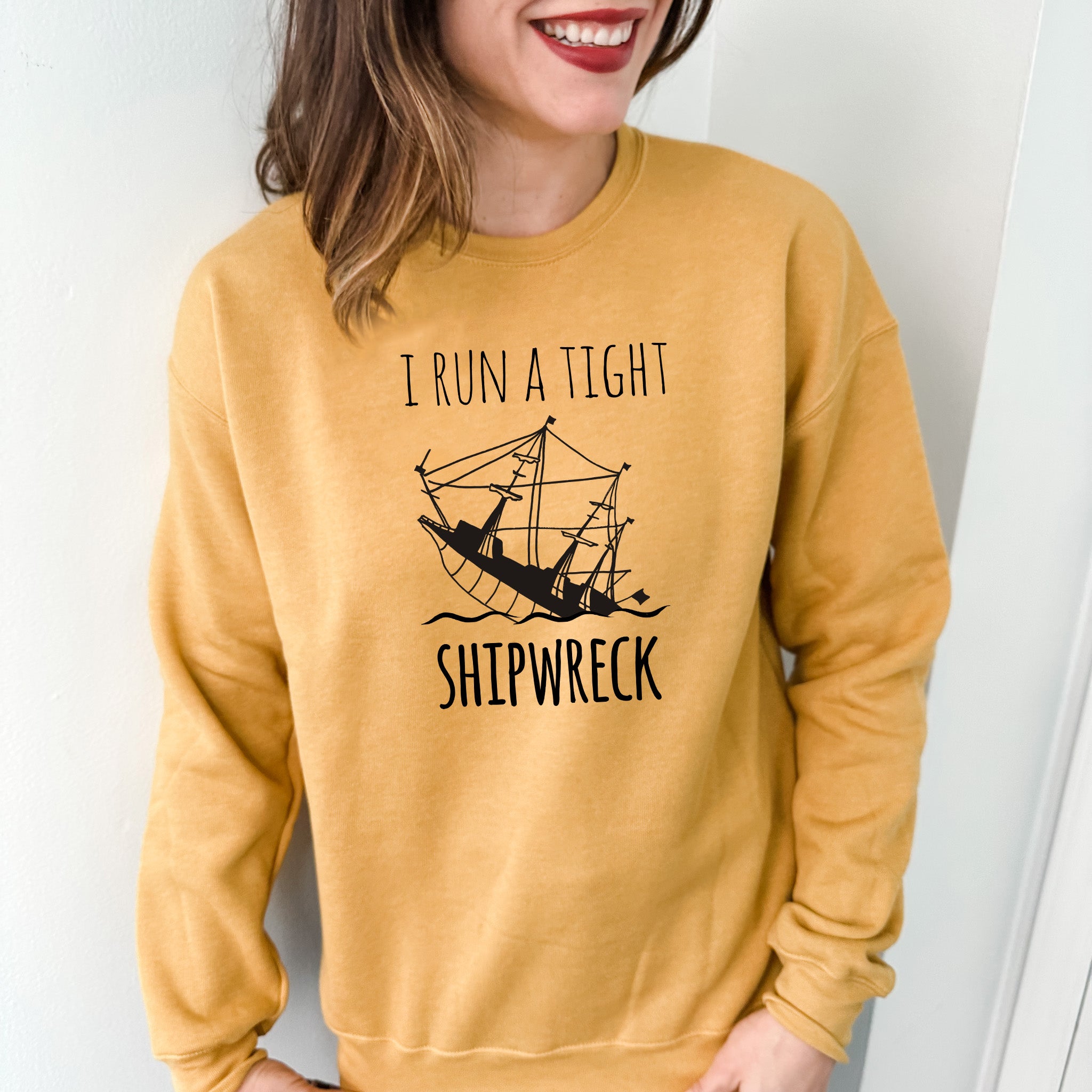a woman wearing a sweatshirt that says i run a tight shipwreck