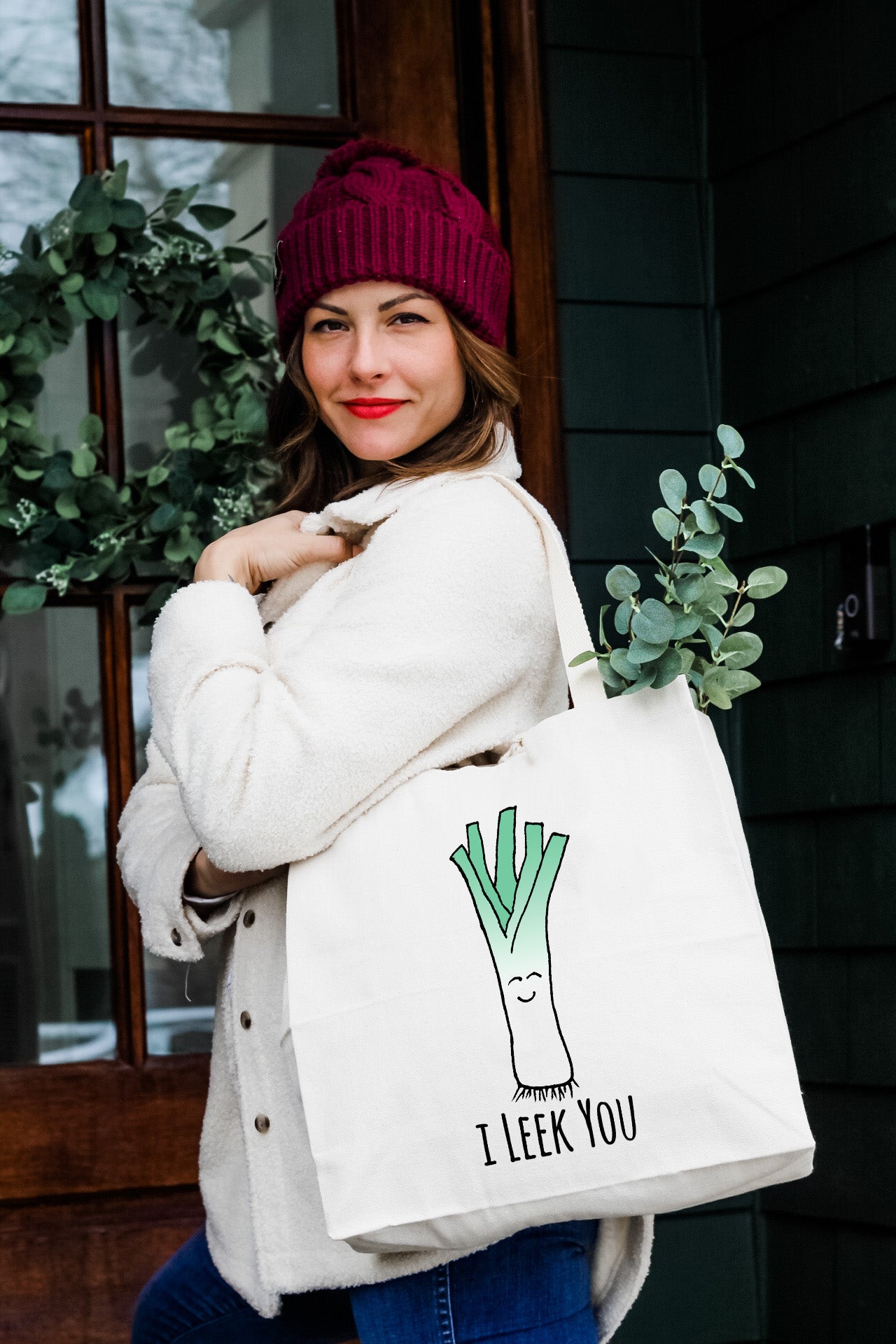 a woman carrying a bag with a plant on it