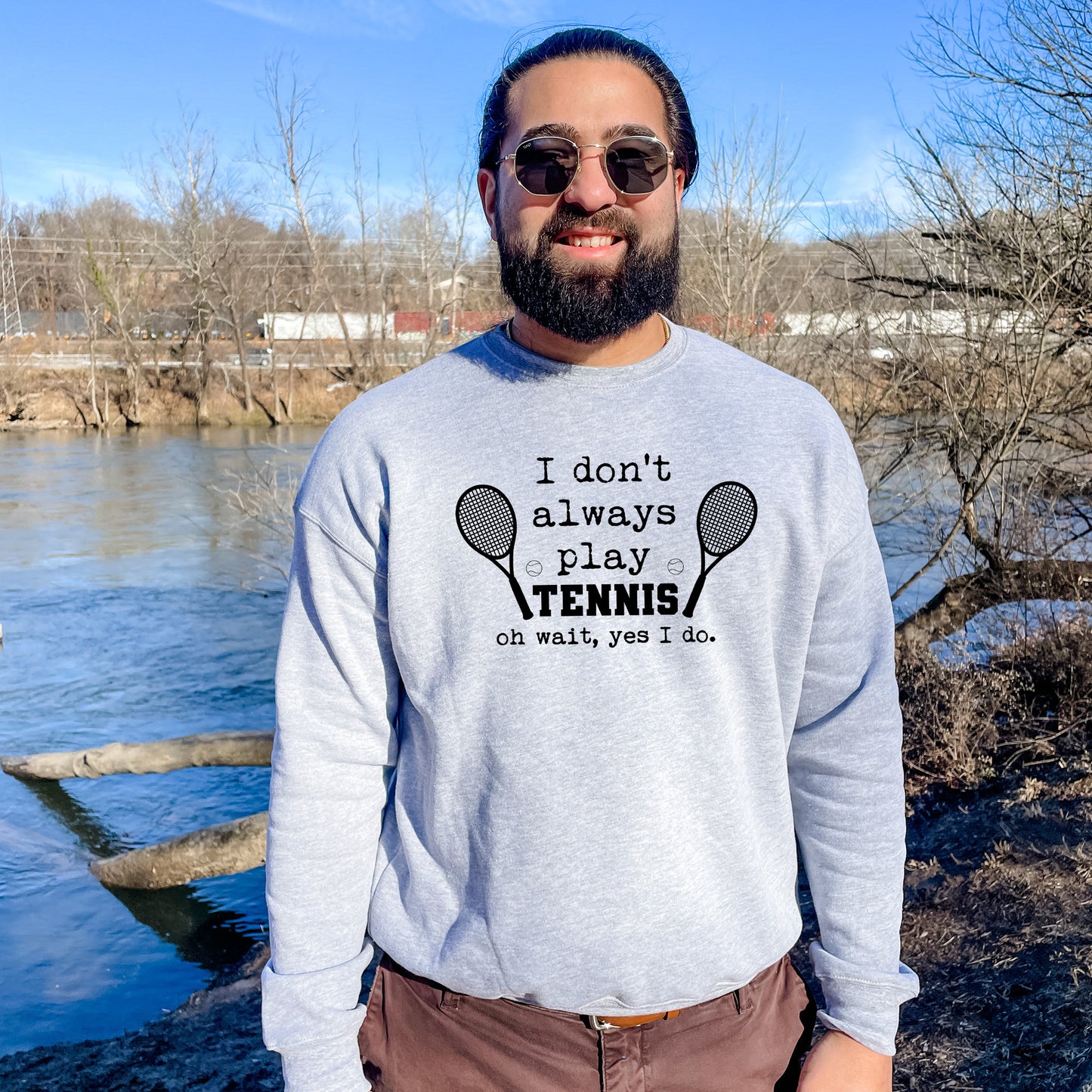 a man wearing a sweatshirt that says i don't always play tennis