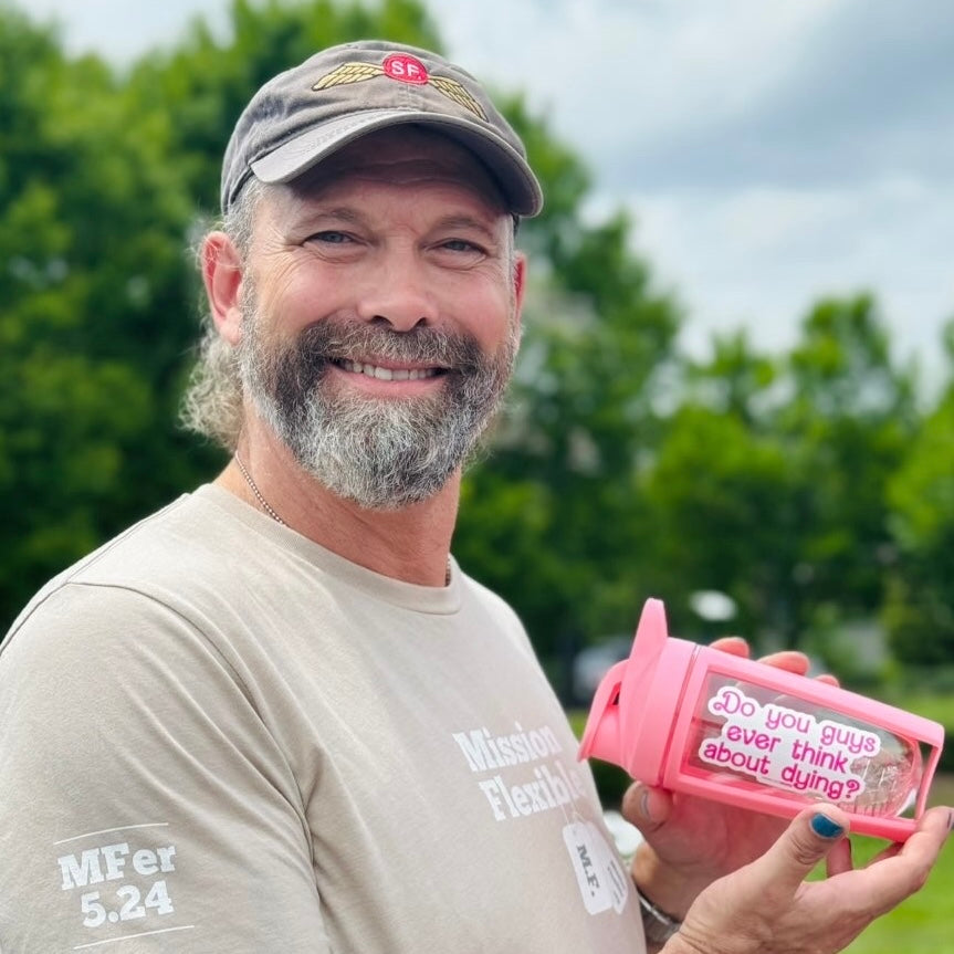 a man with a beard holding a pink cup