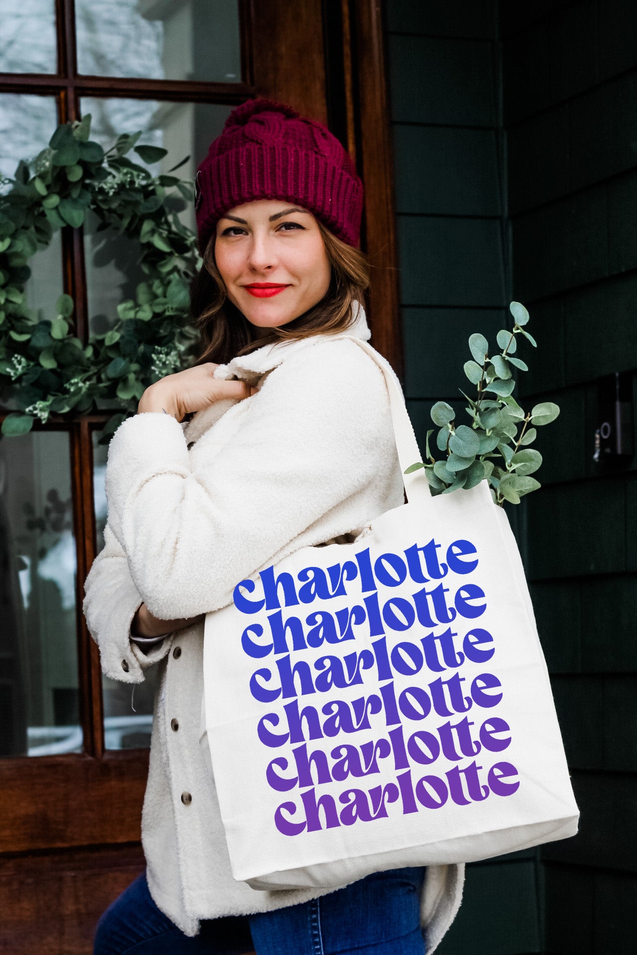 a woman holding a white bag that says charlotte charlotte charlotte charlotte charlotte charlotte