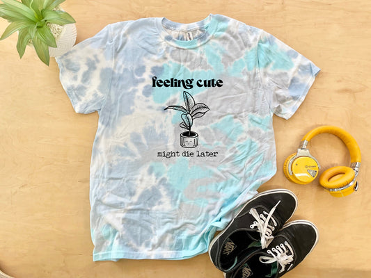 a t - shirt with a plant and headphones next to it