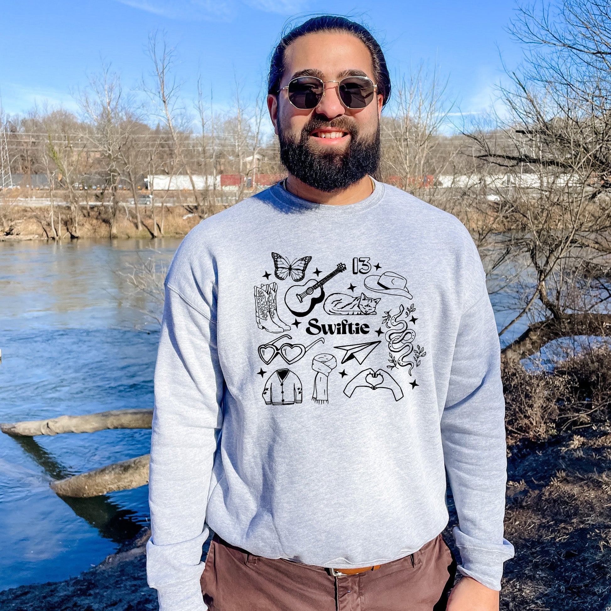 a man standing in front of a body of water