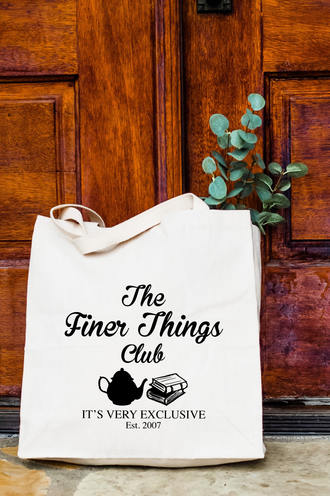 a white bag sitting on top of a wooden door