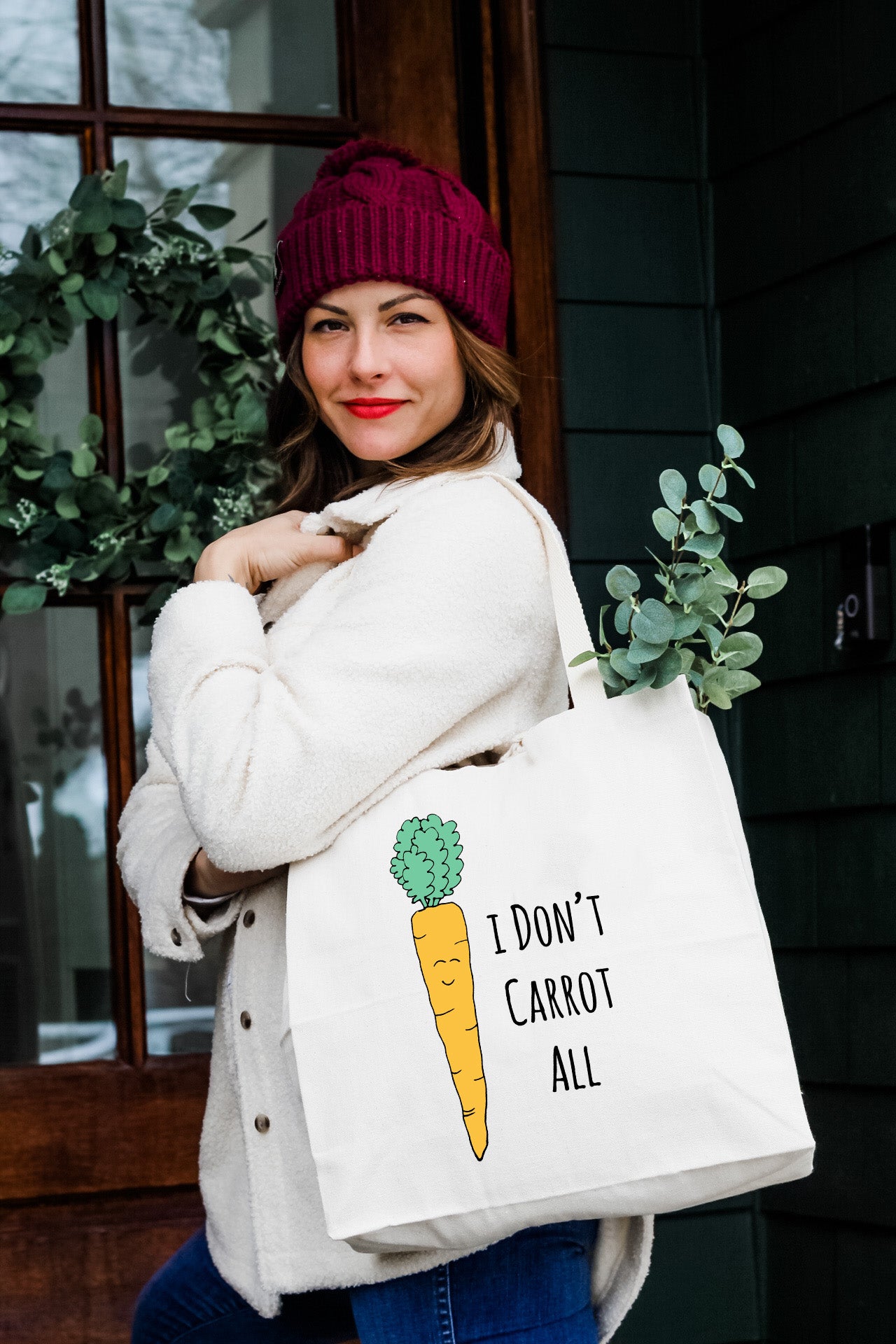 a woman carrying a bag with a carrot on it
