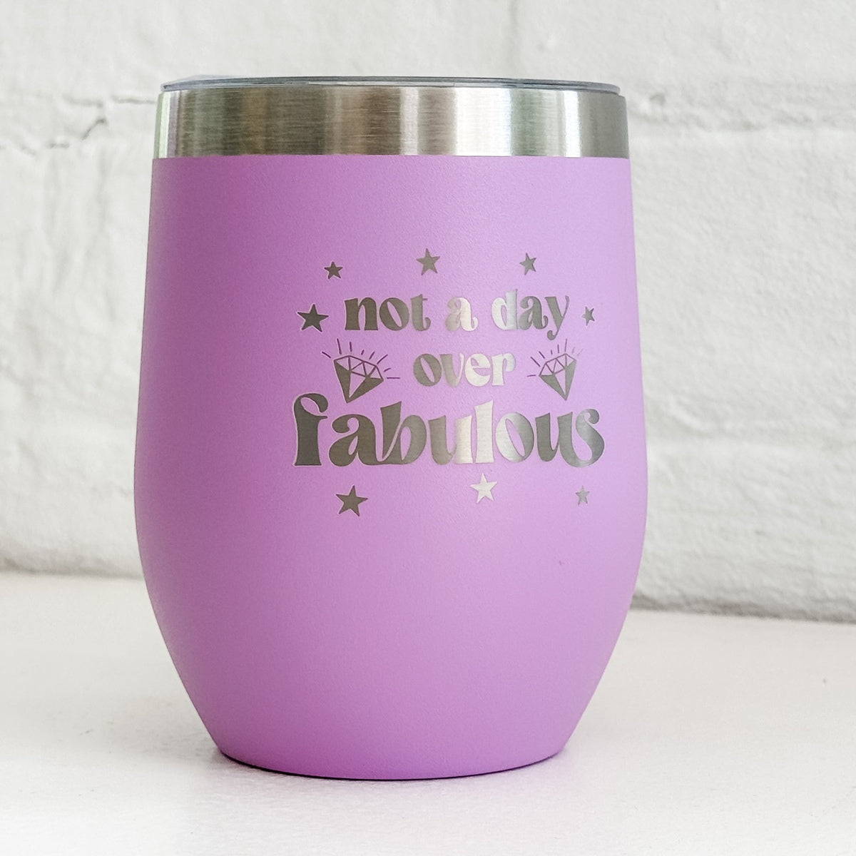 a purple cup with gold lettering on it