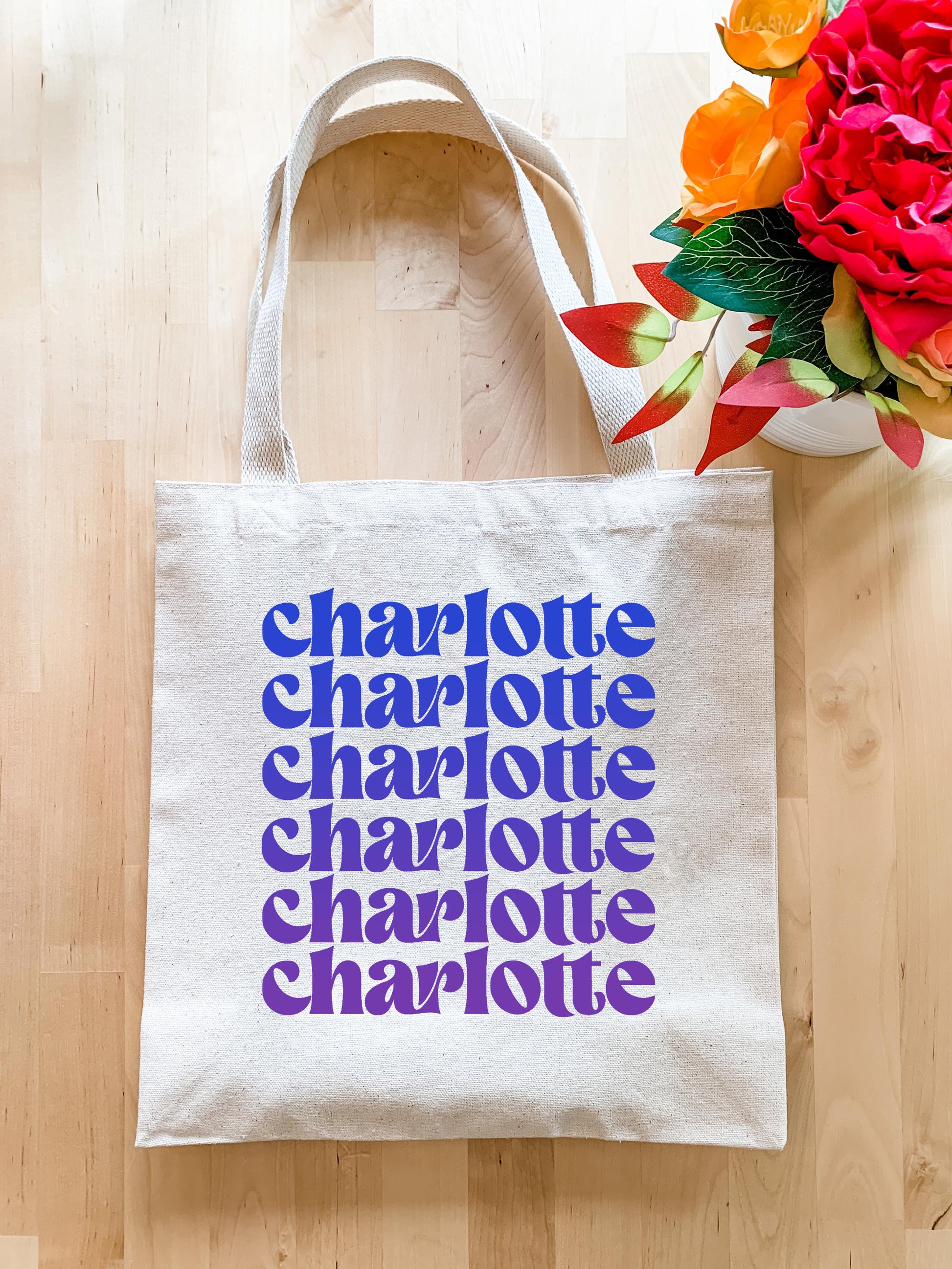 a tote bag sitting on top of a wooden floor