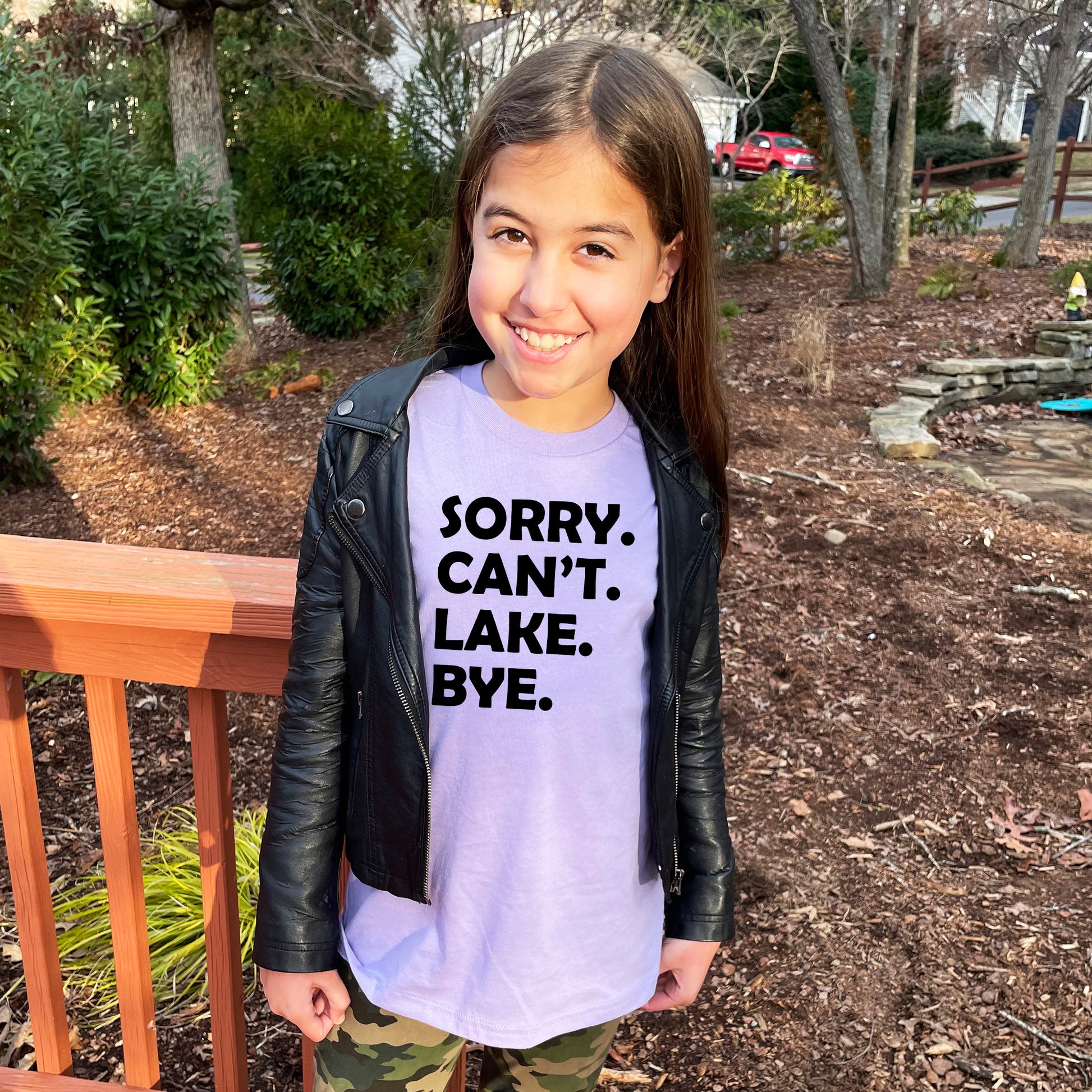 a young girl wearing a t - shirt that says sorry, can't,