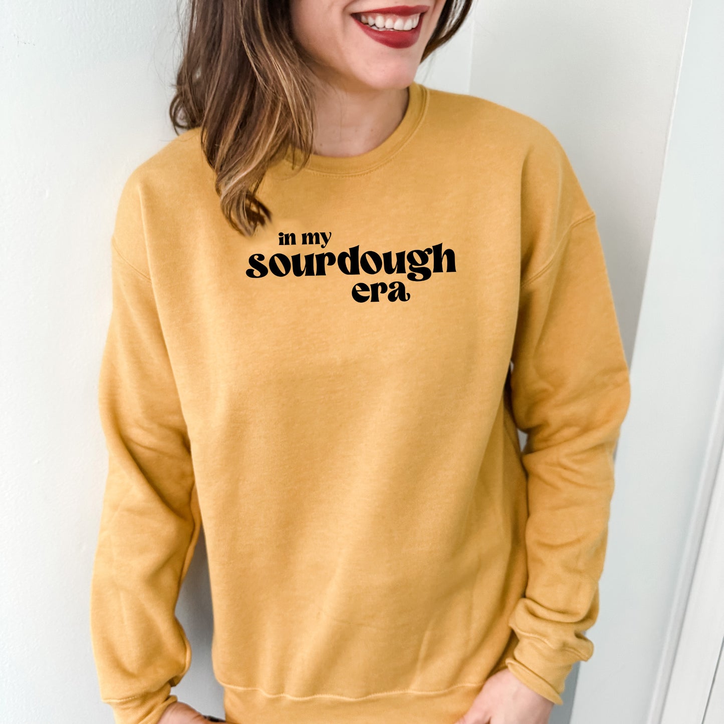 a woman wearing a sweatshirt that says, in my sourdough era