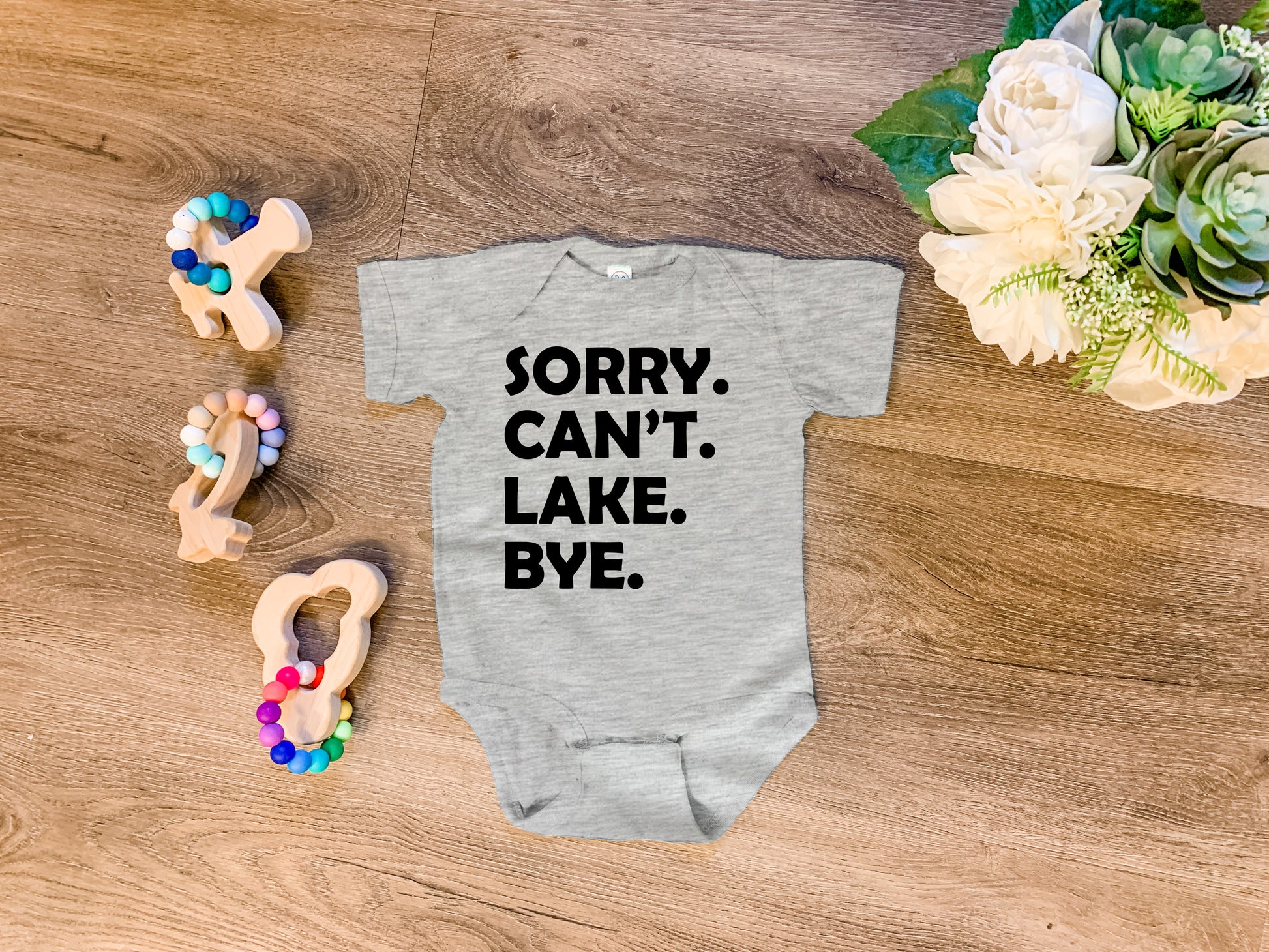 a baby bodysuit that says sorry can't lake bye