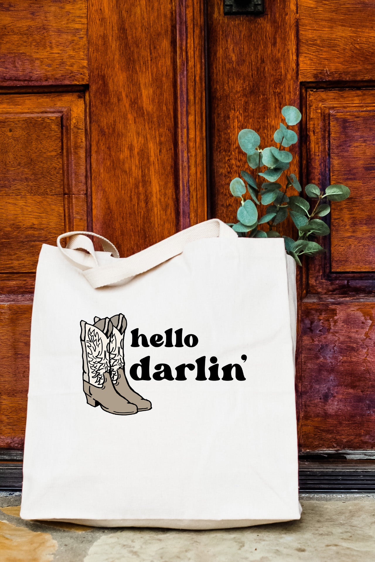 a white tote bag with a picture of a boot and the words hello dar