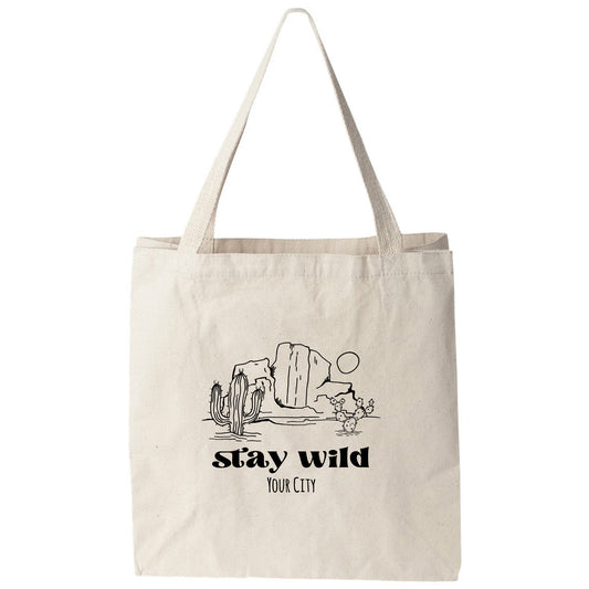 a white tote bag with the words stay wild on it