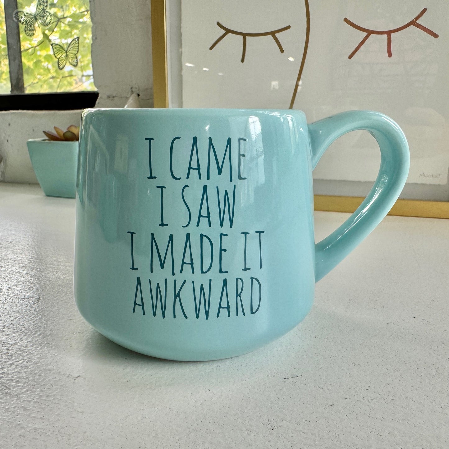 a blue coffee mug that says i came i saw i made it awkward