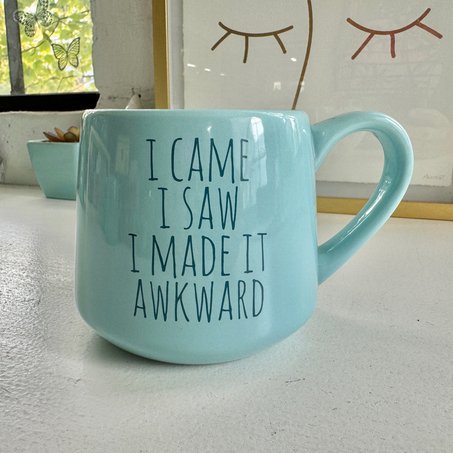 a blue coffee mug that says i came i saw i made it awkward