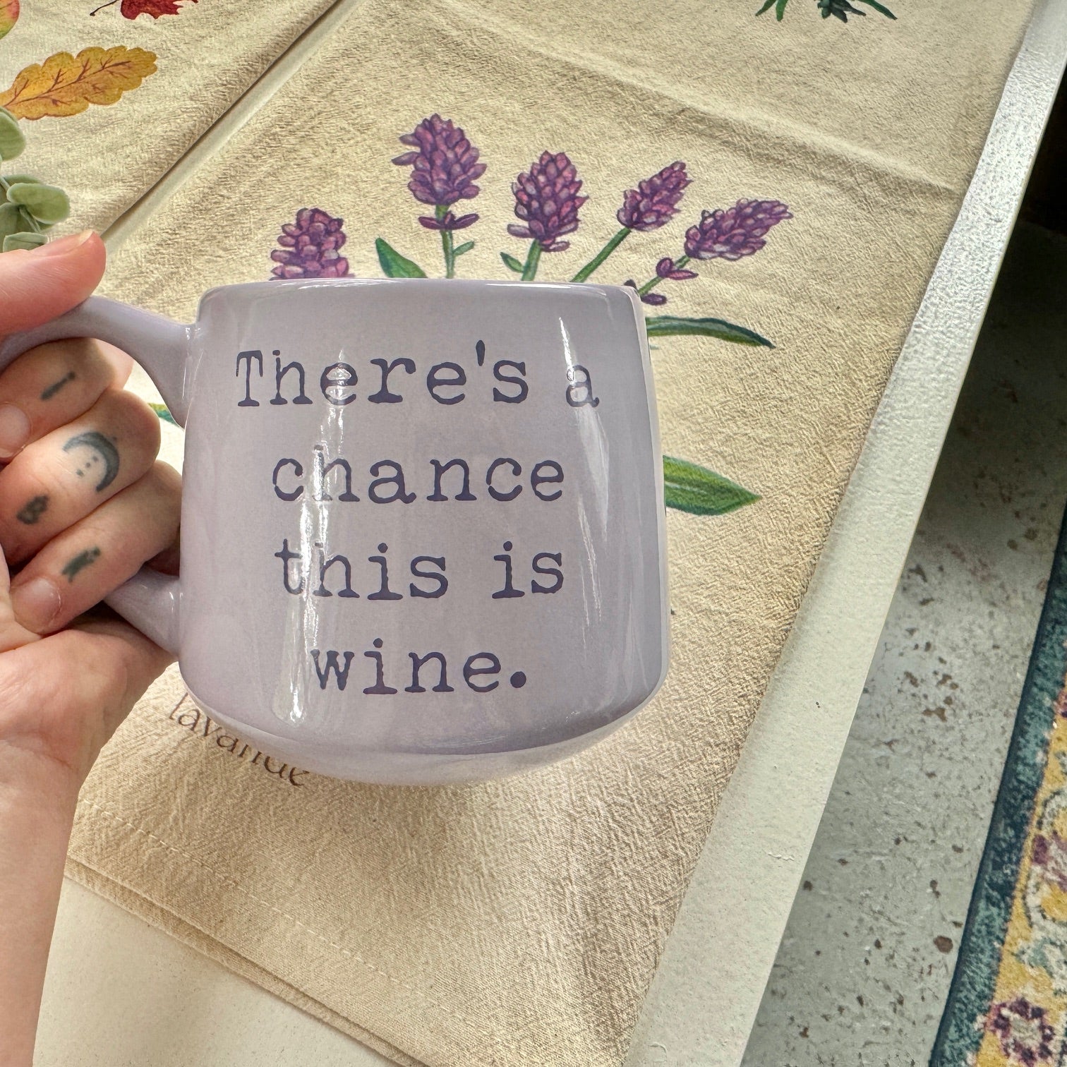 a woman holding a coffee mug with a saying on it