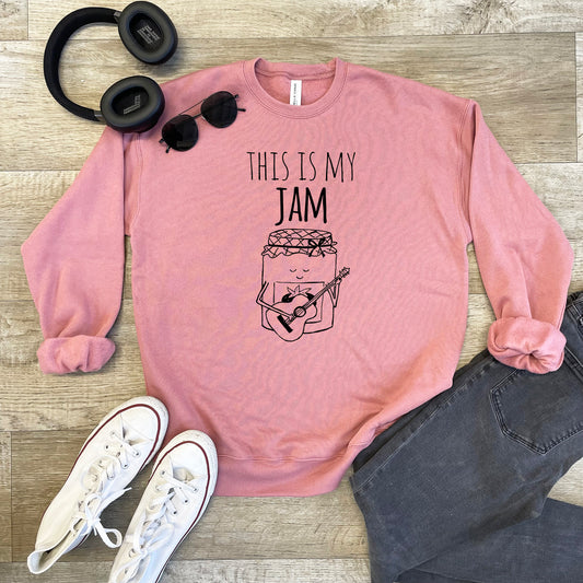 a pink sweatshirt with a jar of jam and headphones