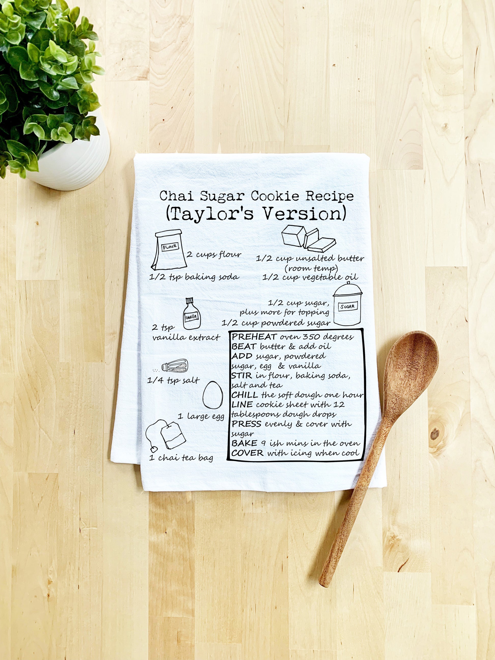 a recipe book with a wooden spoon on a table