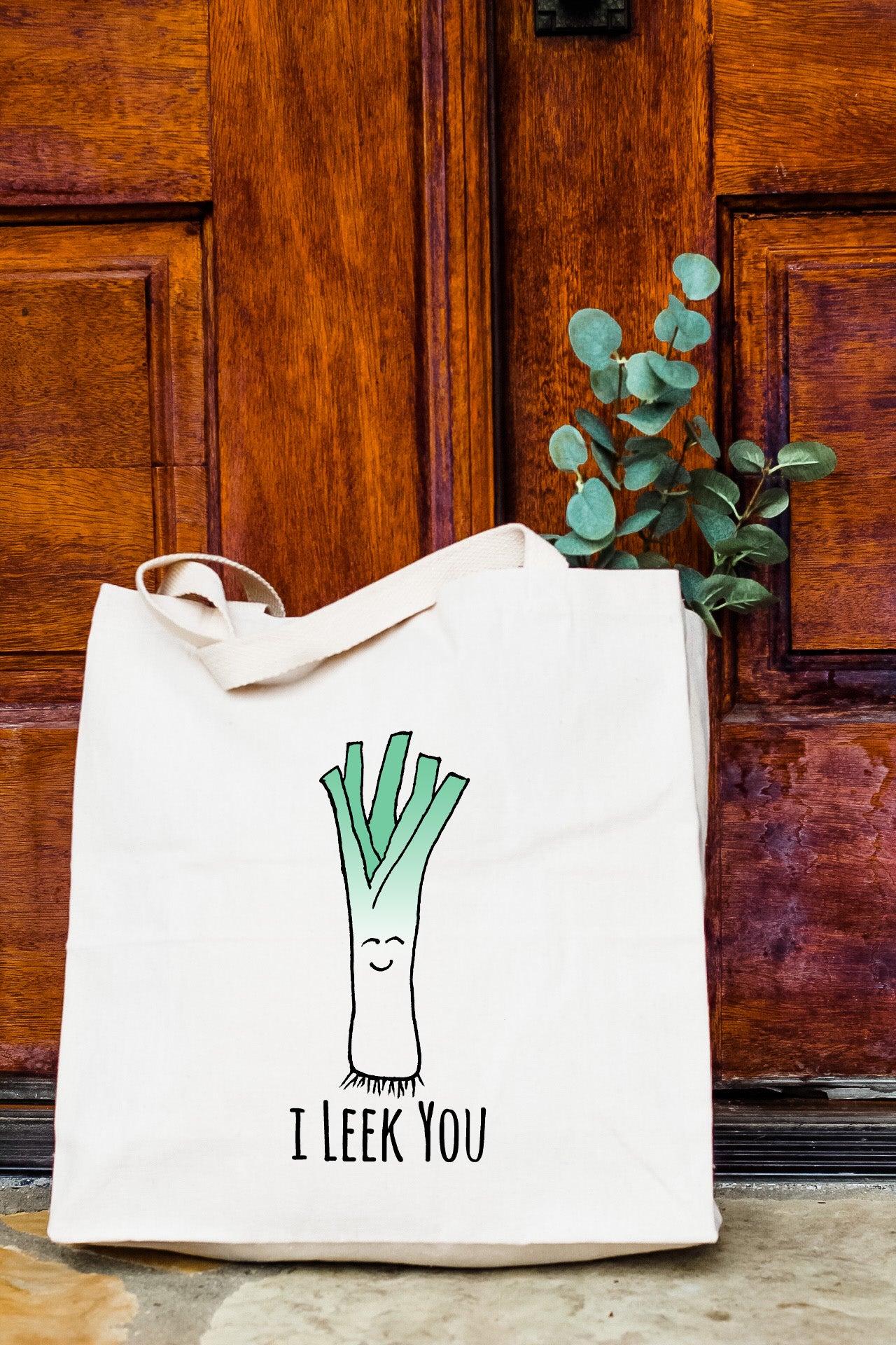 a white tote bag with a picture of a leek on it