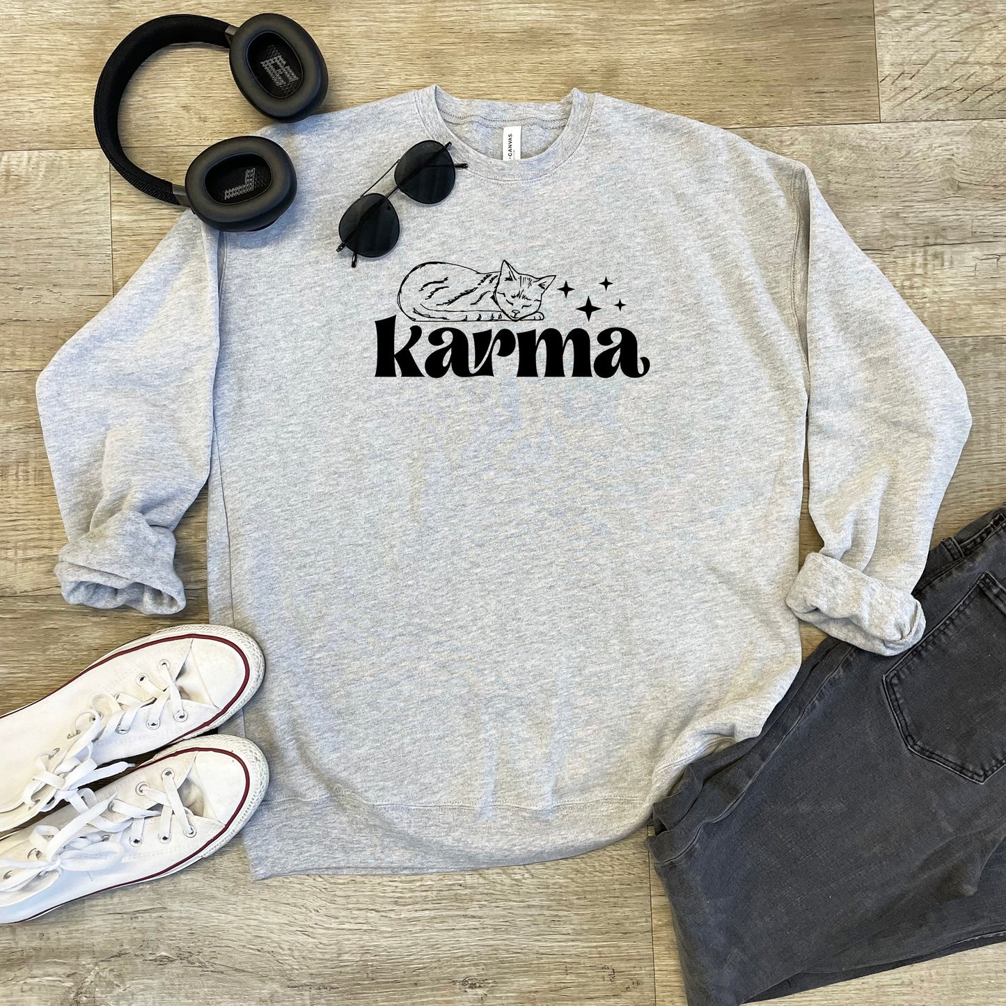 a sweatshirt that says karma with headphones on top of it