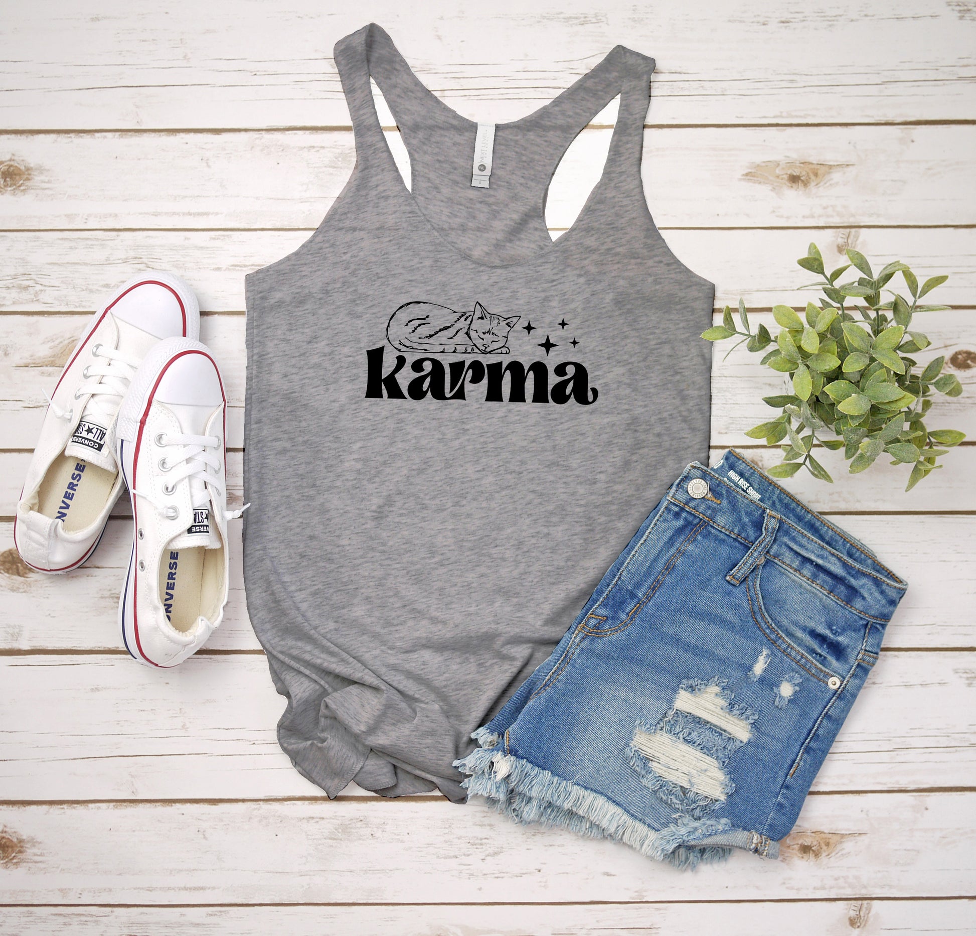 a tank top that says karma next to a pair of shorts