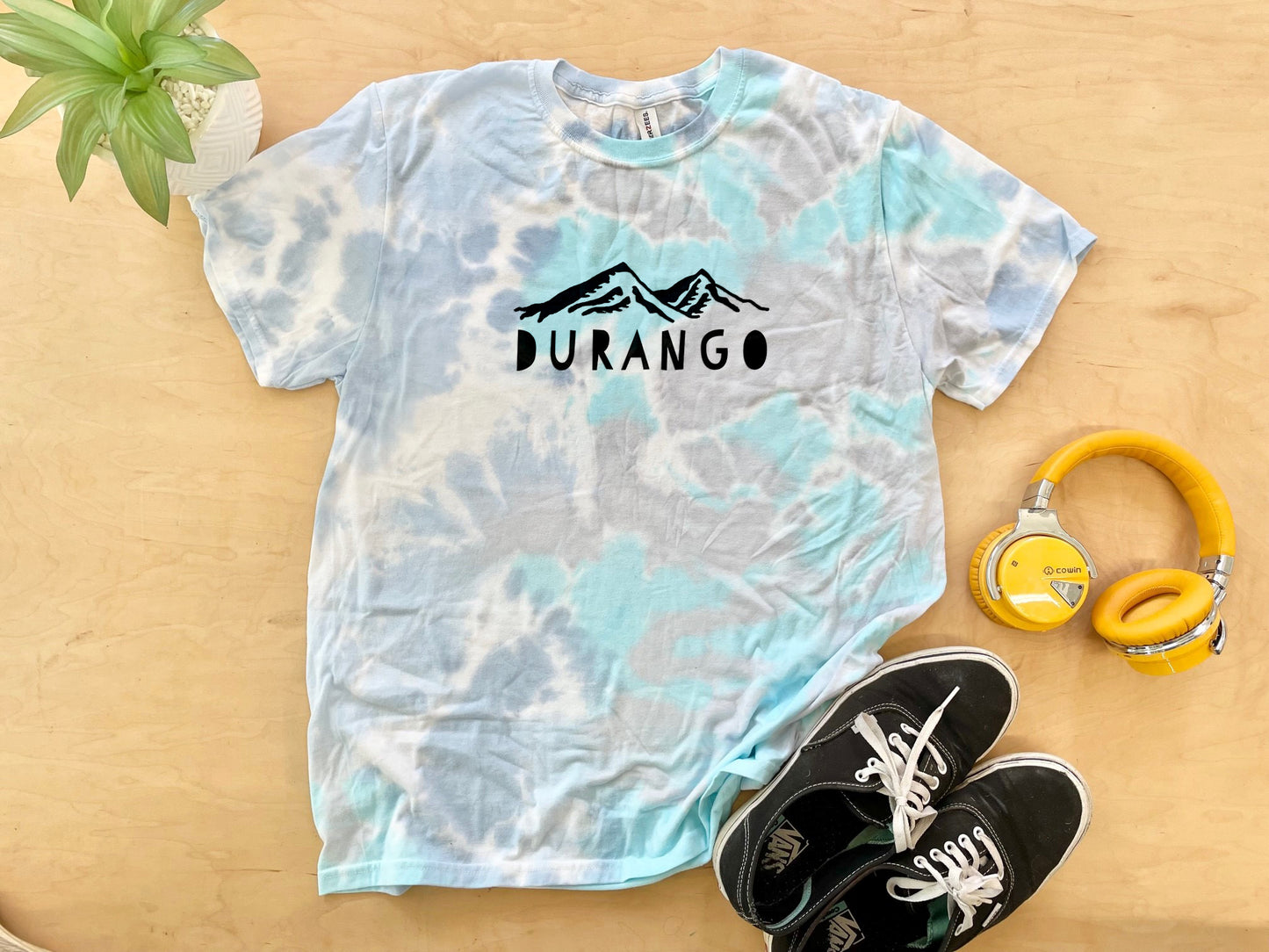 a t - shirt with the word durano on it next to headphones and