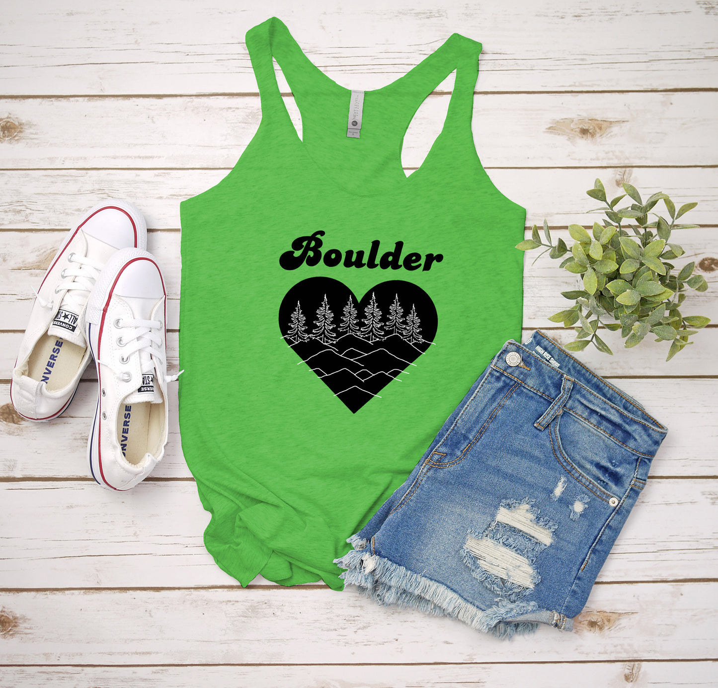 a green tank top with a heart and trees on it