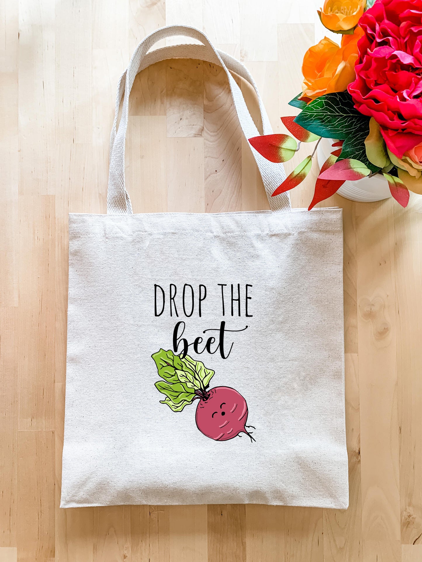 a tote bag with the words drop the beet on it