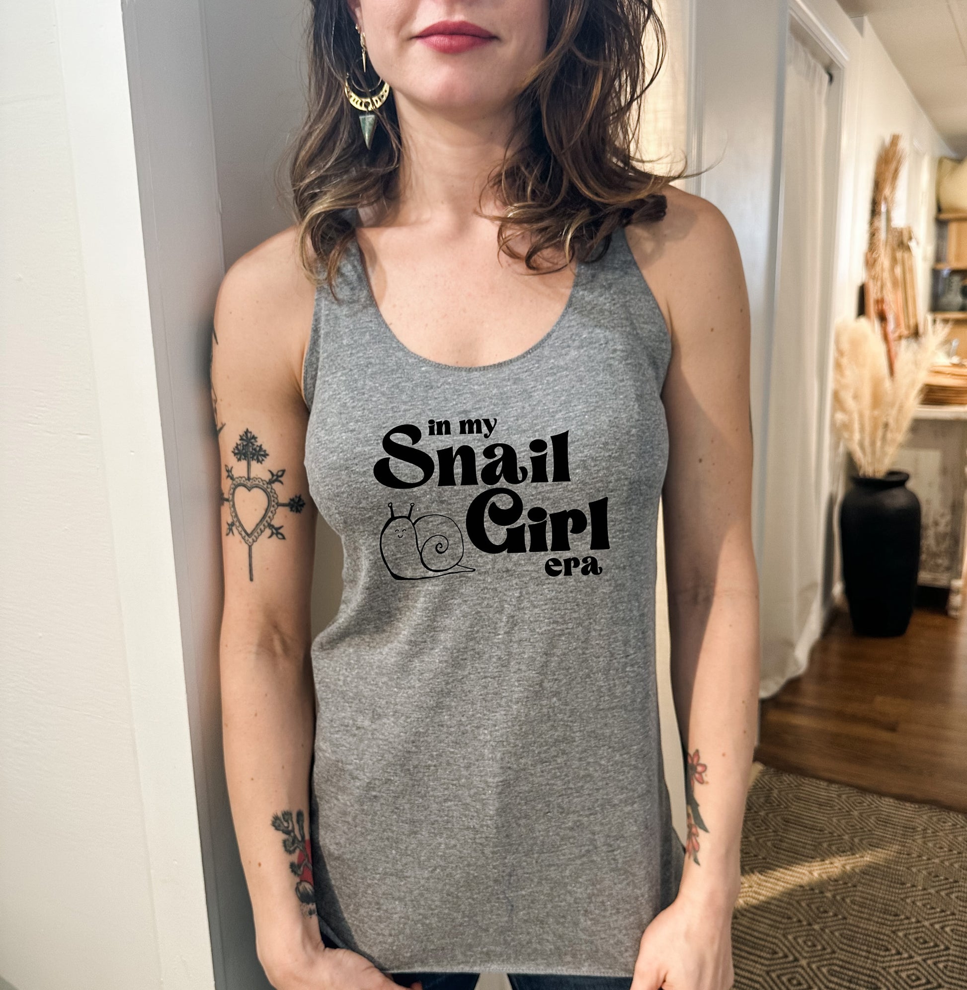 a woman wearing a tank top that says in my small girl
