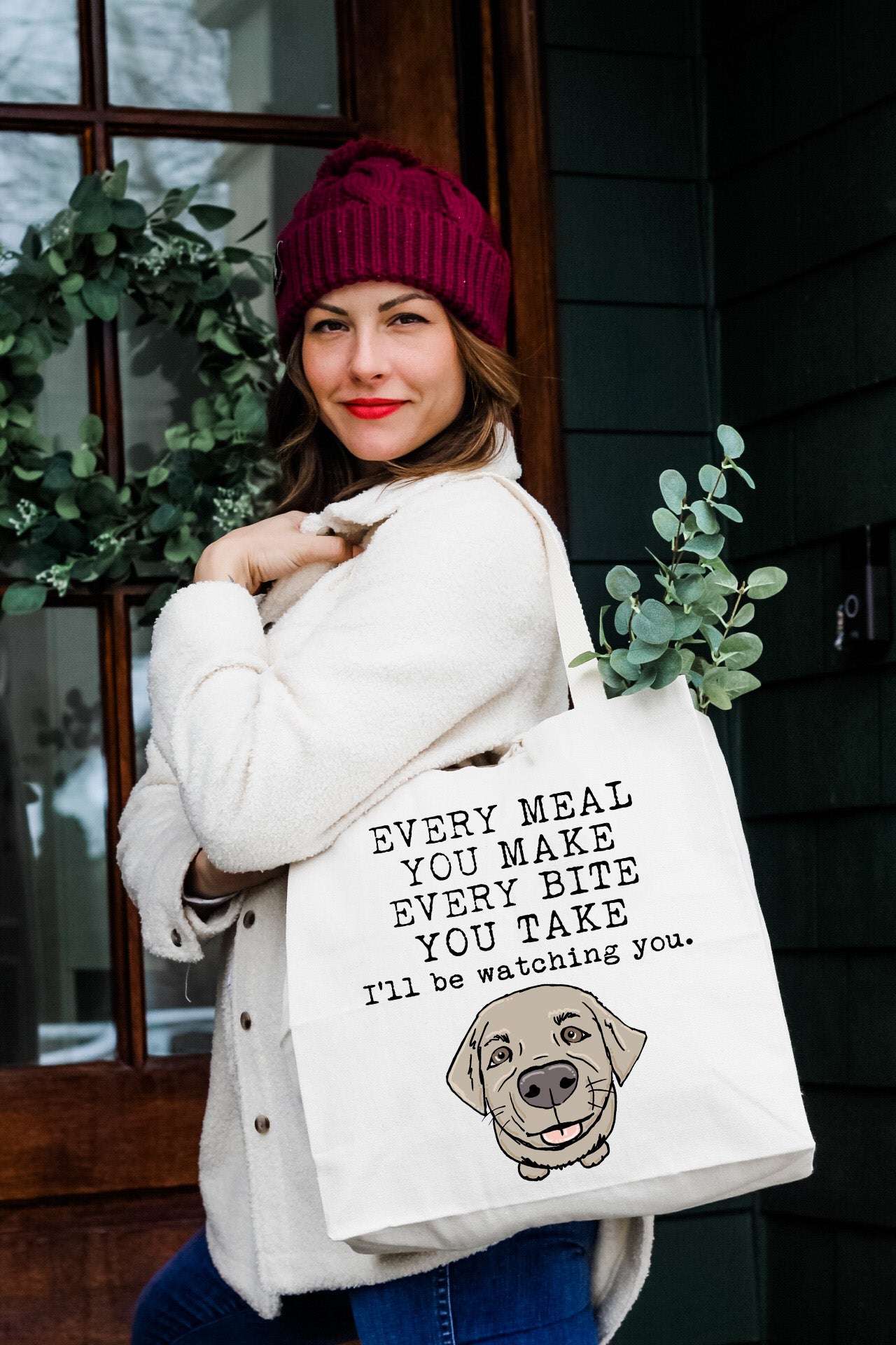 a woman carrying a bag with a dog on it